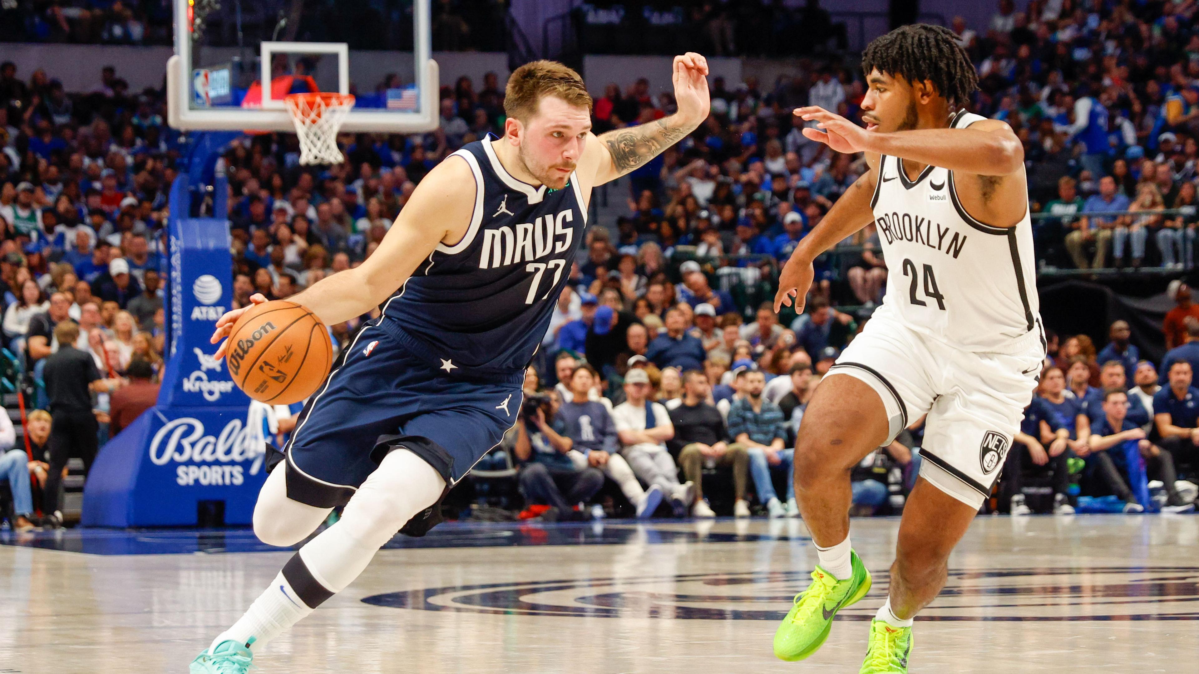 Dallas Mavericks guard Luka Doncic (77) drives on Brooklyn Nets guard Cam Thomas (24) during the second quarter at American Airlines Center.