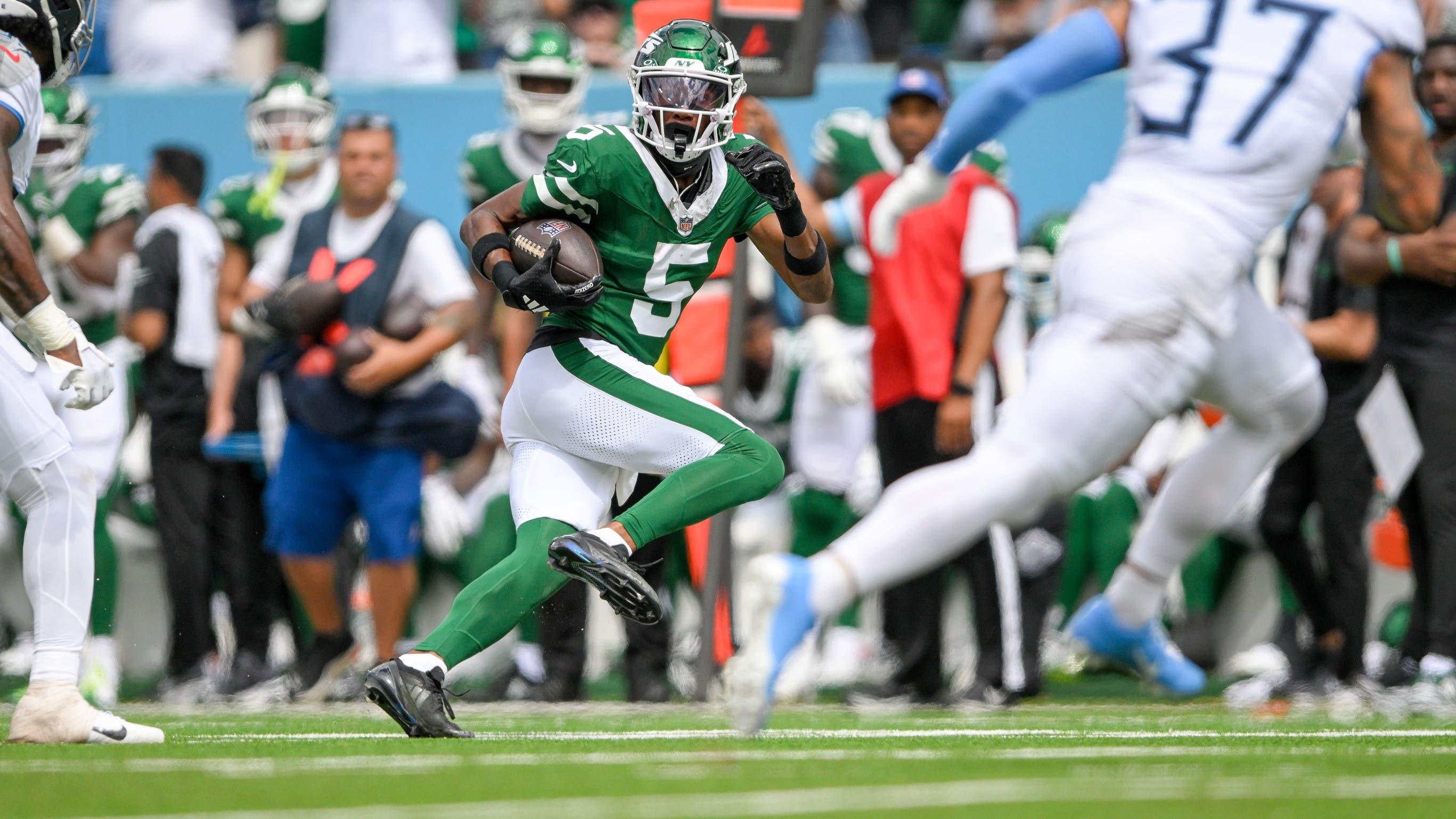 Sep 15, 2024; Nashville, Tennessee, USA; New York Jets wide receiver Garrett Wilson (5) runs the ball against the Tennessee Titans during the second half at Nissan Stadium.