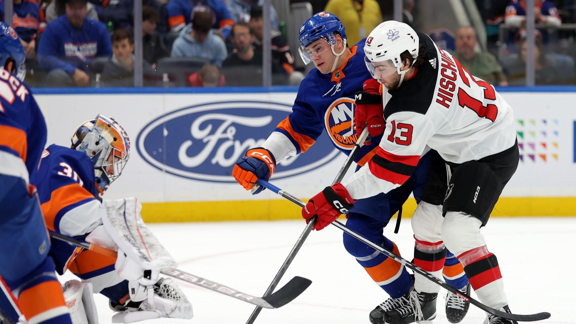 Oct 20, 2023; Elmont, New York, USA; New Jersey Devils center Nico Hischier (13) takes a shot against New York Islanders goaltender Ilya Sorokin (30) and defenseman Alexander Romanov (28) during the first period at UBS Arena.