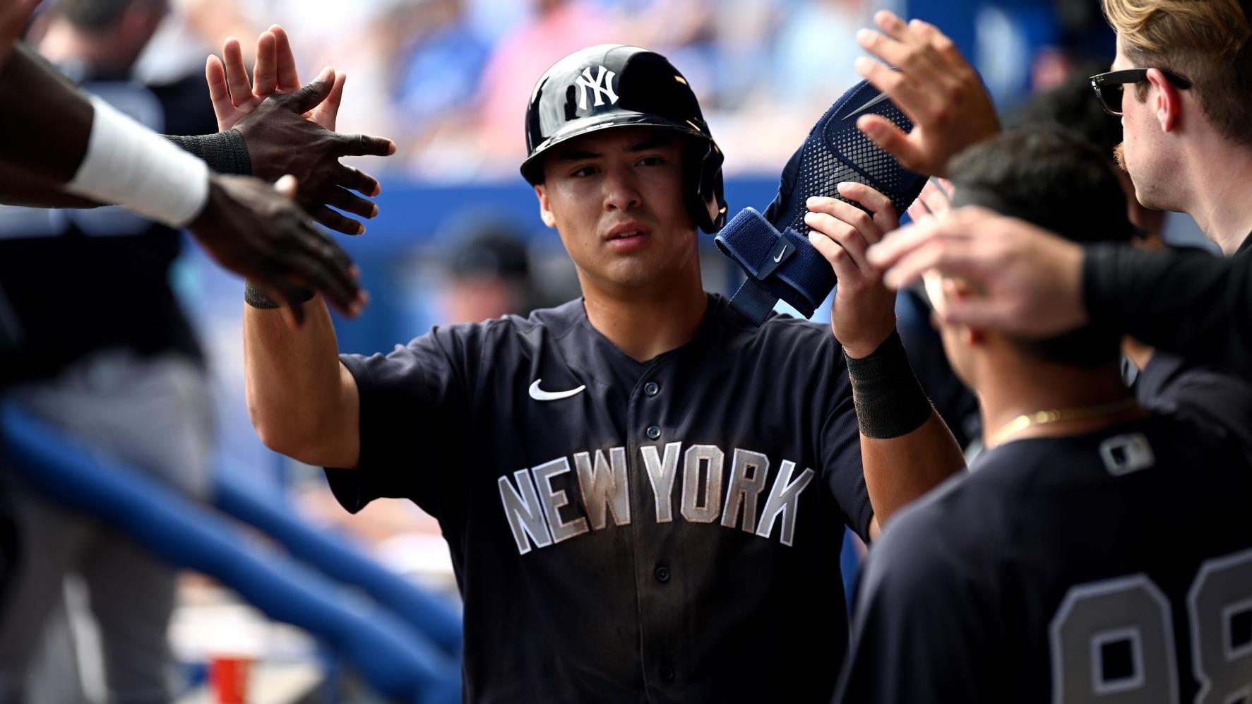 Feb 26, 2023; Dunedin, Florida, USA; New York Yankees shortstop Anthony Volpe (77) celebrates with his teammates after scoring a run in the third inning against the Toronto Blue Jays at TD Ballpark.