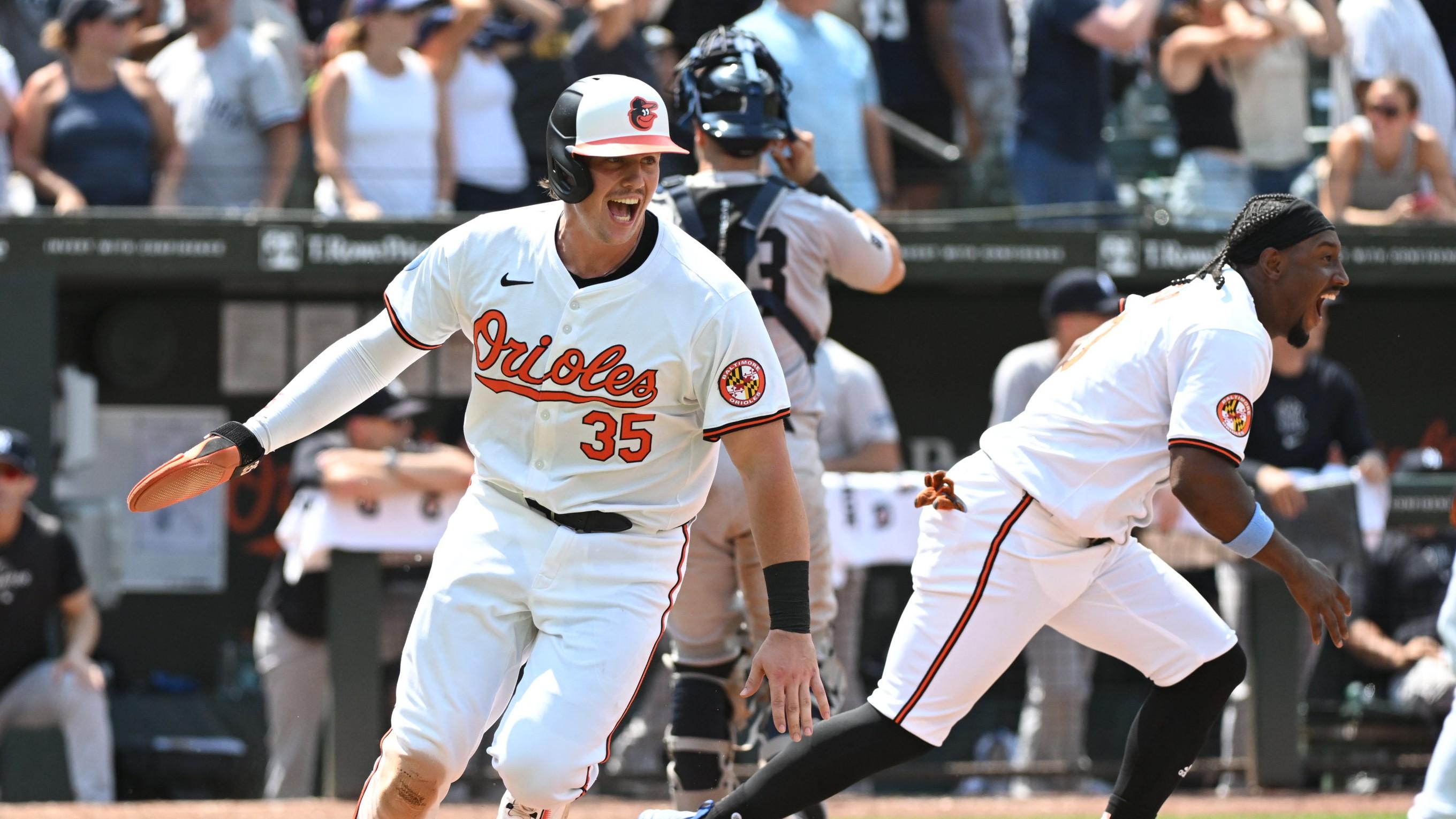 Jul 14, 2024; Baltimore, Maryland, USA; Baltimore Orioles catcher Adley Rutschman (35) reacts to scoring the winning run during the ninth inning against the New York Yankees at Oriole Park at Camden Yards. Mandatory Credit: James A. Pittman-USA TODAY Sports