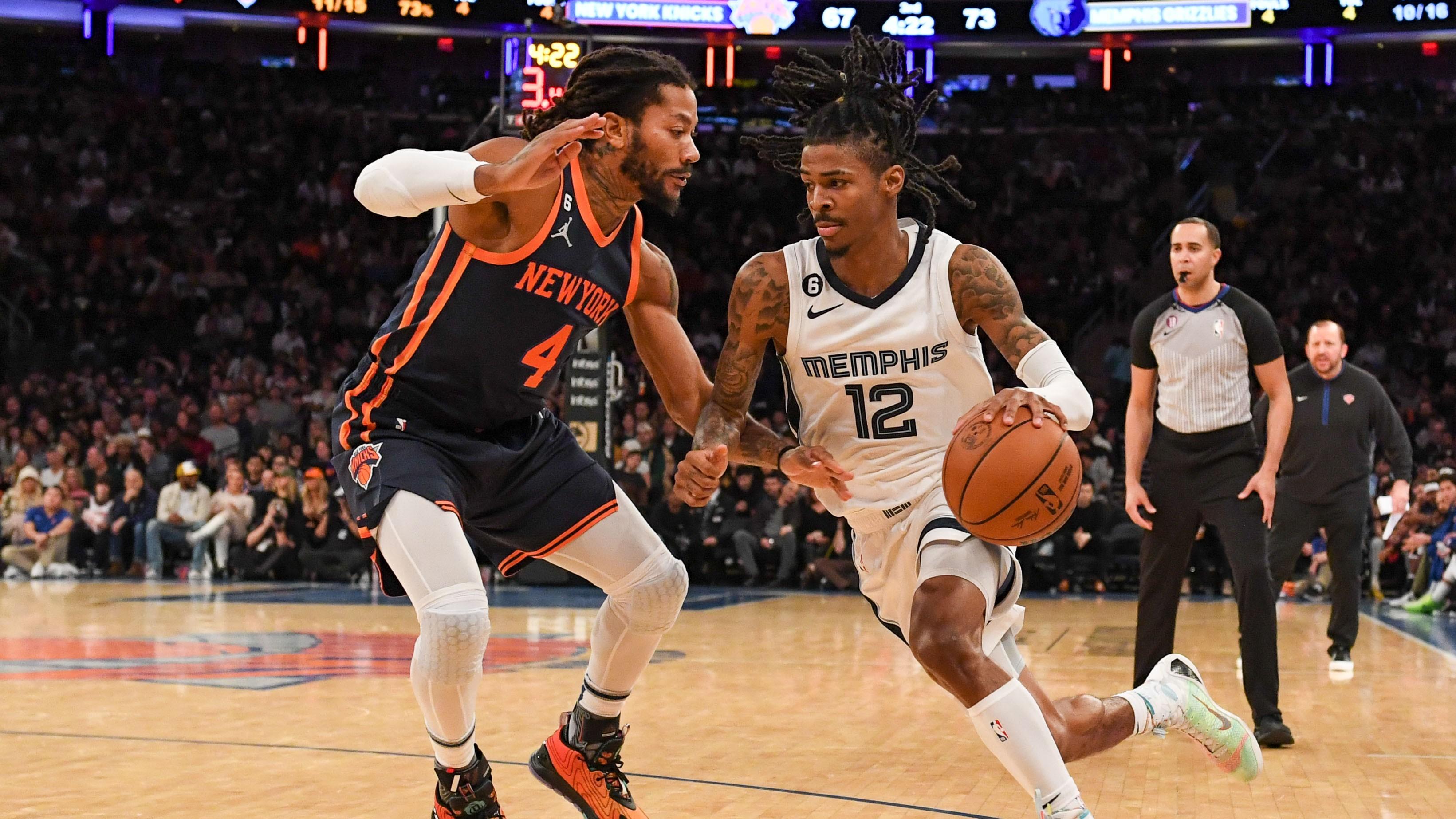 Nov 27, 2022; New York, New York, USA; Memphis Grizzlies guard Ja Morant (12) drives to the basket on New York Knicks guard Derrick Rose (4) during the third quarter at Madison Square Garden. Mandatory Credit: Dennis Schneidler-USA TODAY Sports