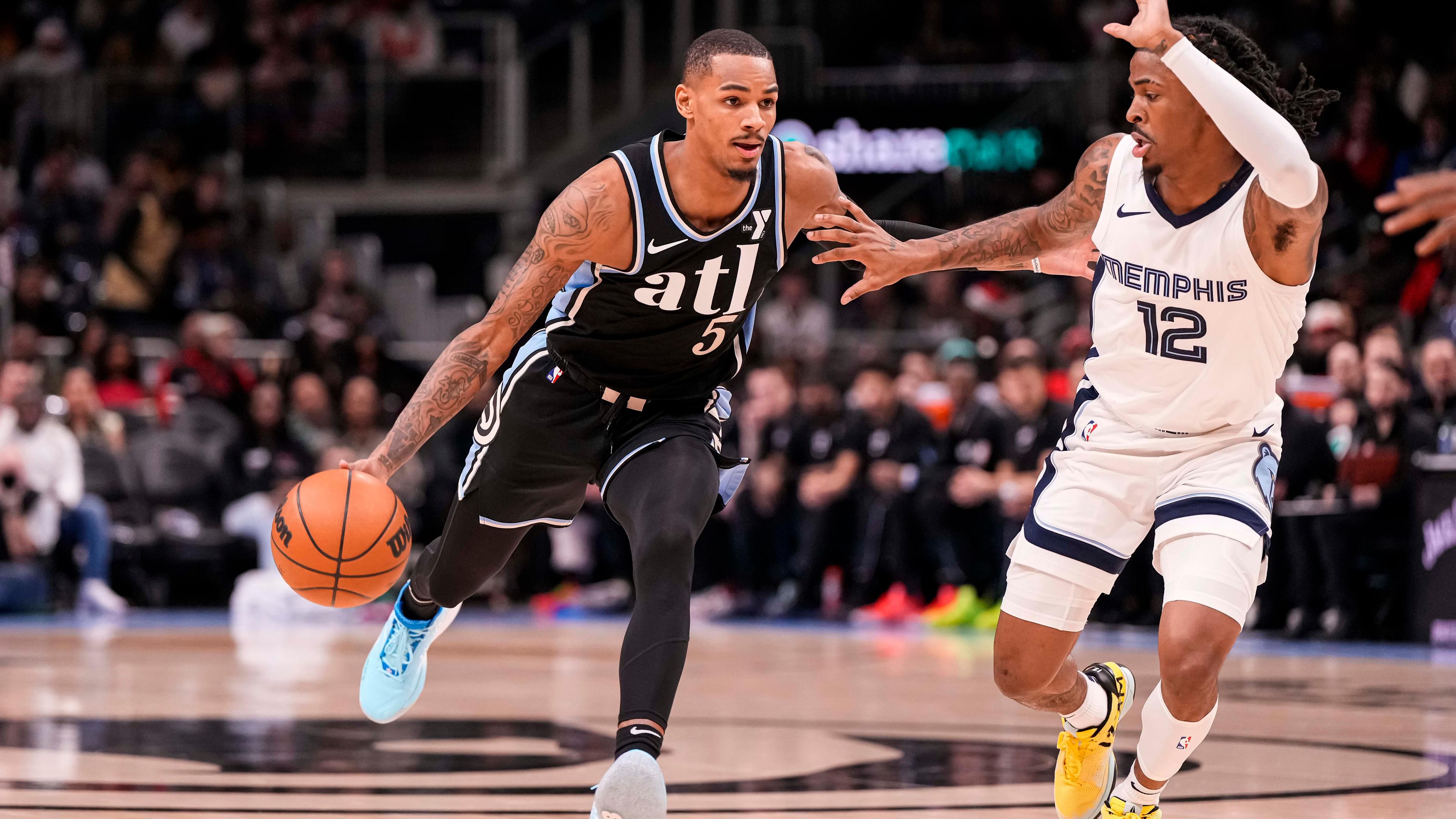 Atlanta Hawks guard Dejounte Murray (5) dribbles against Memphis Grizzlies guard Ja Morant (12) during the first half at State Farm Arena. / Dale Zanine-USA TODAY Sports