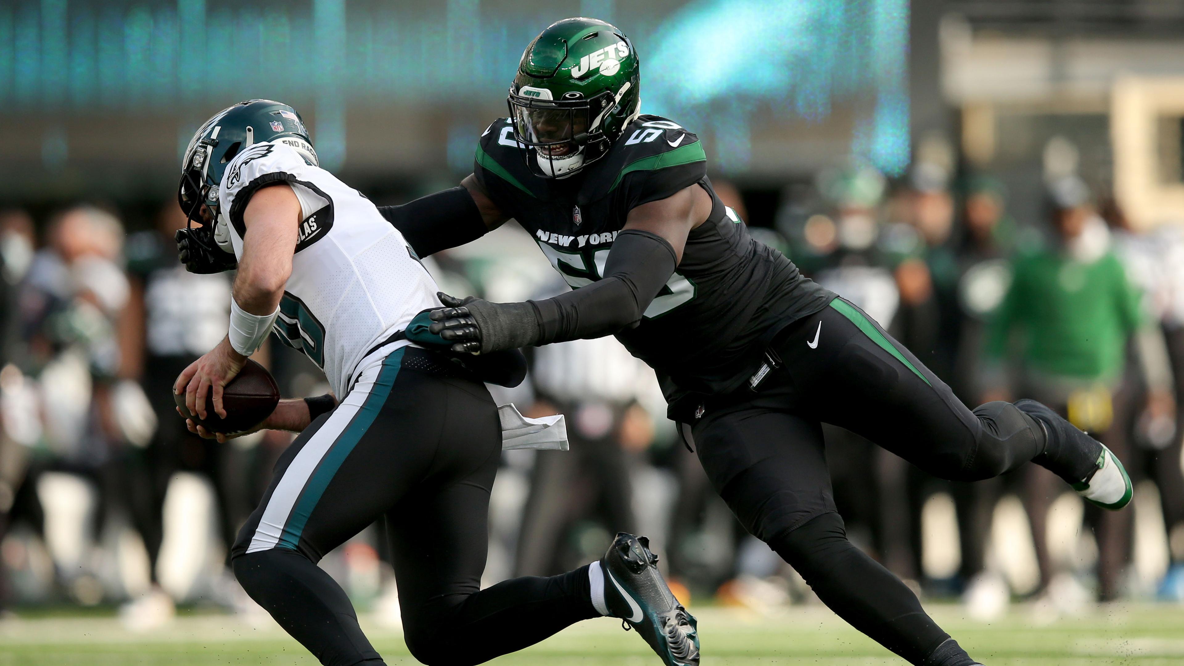 Dec 5, 2021; East Rutherford, New Jersey, USA; Philadelphia Eagles quarterback Gardner Minshew (10) is sacked by New York Jets defensive end Shaq Lawson (50) during the second quarter at MetLife Stadium. Lawson was called for a facemask penalty on the play.