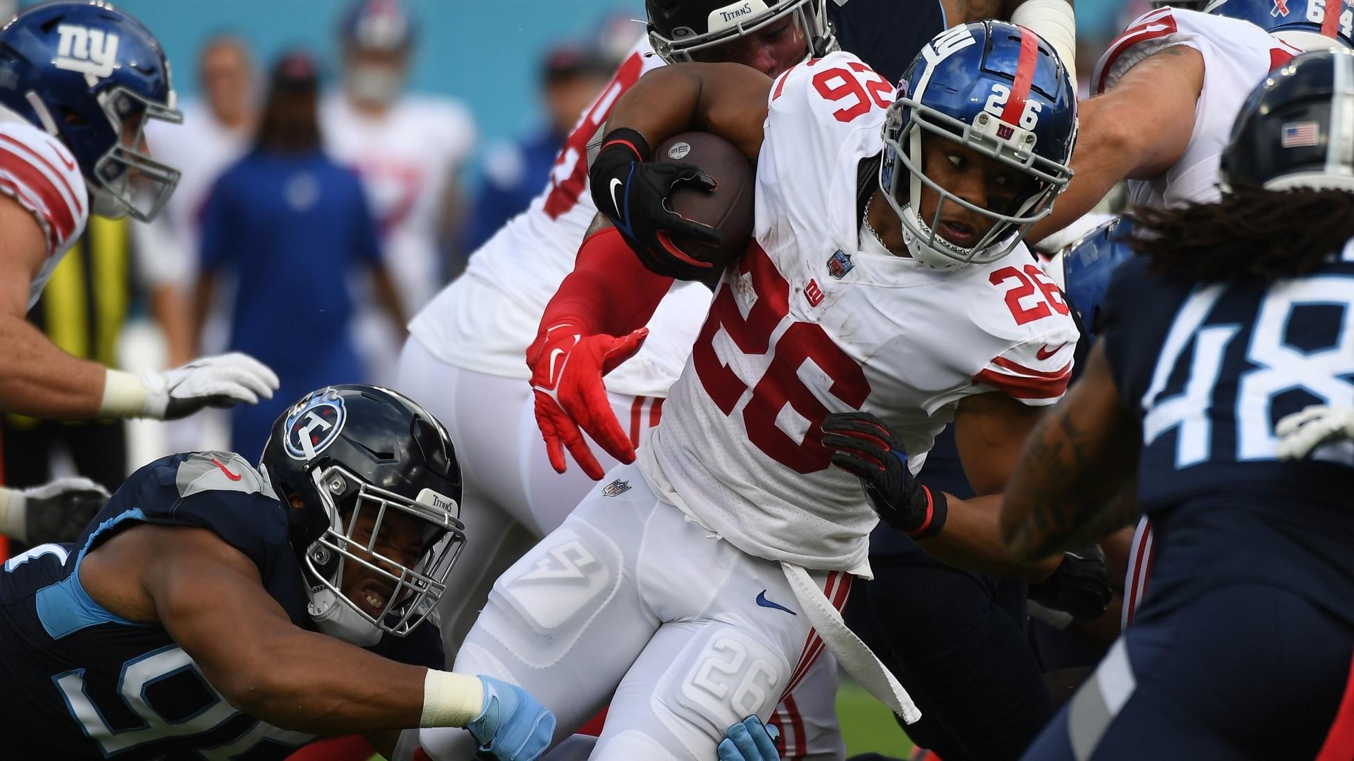 Sep 11, 2022; Nashville, Tennessee, USA; New York Giants running back Saquon Barkley (26) is stopped after a short gain during the first half against the Tennessee Titans at Nissan Stadium.