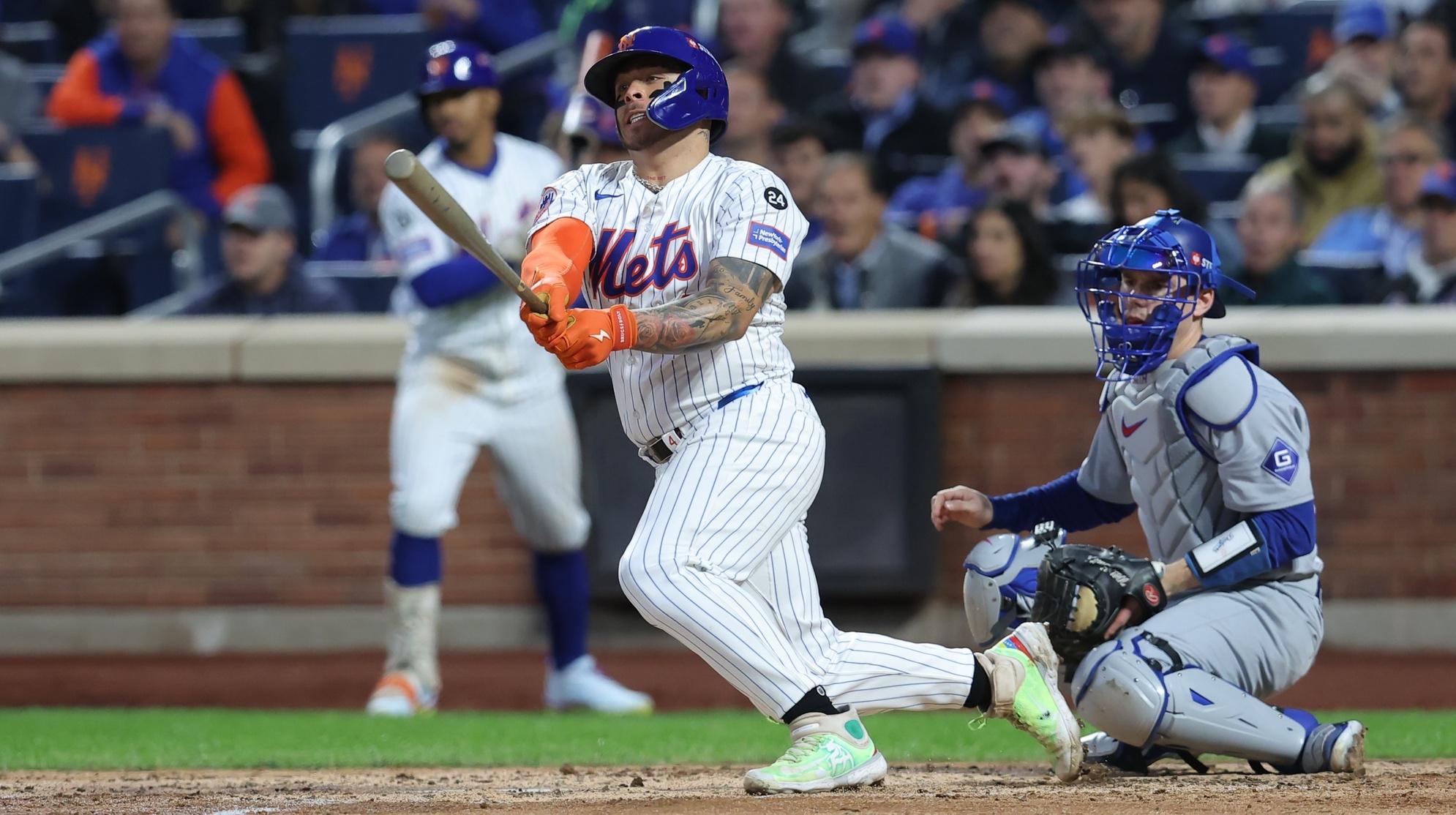 New York Mets catcher Francisco Alvarez (4) hits a single in the third inning against the Los Angeles Dodgers during game five of the NLCS for the 2024 MLB playoffs at Citi Field.