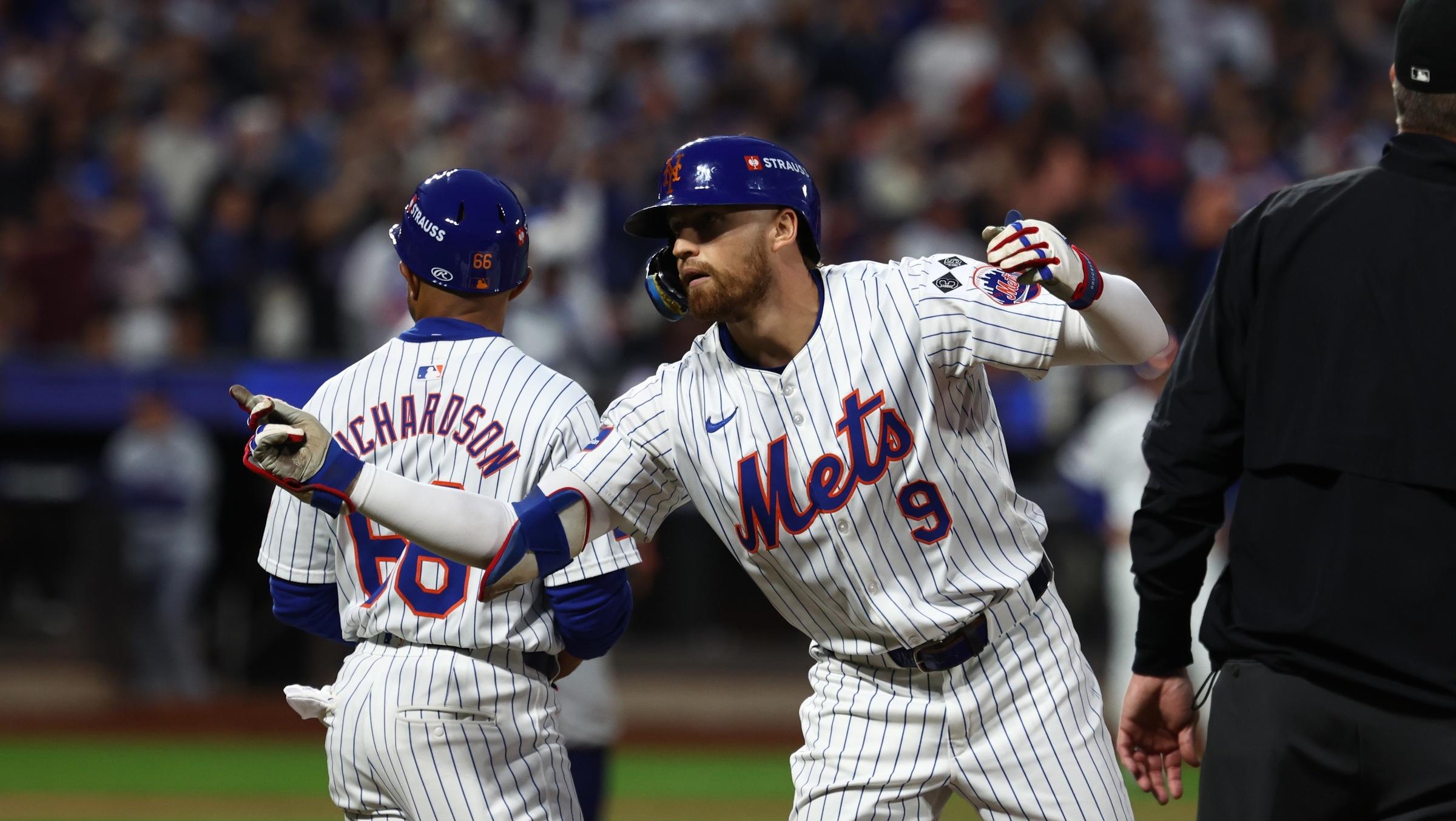 New York Mets left fielder Brandon Nimmo (9) celebrates after hitting a RBI single during the third inning against the Los Angeles Dodgers during game five of the NLCS for the 2024 MLB playoffs at Citi Field.