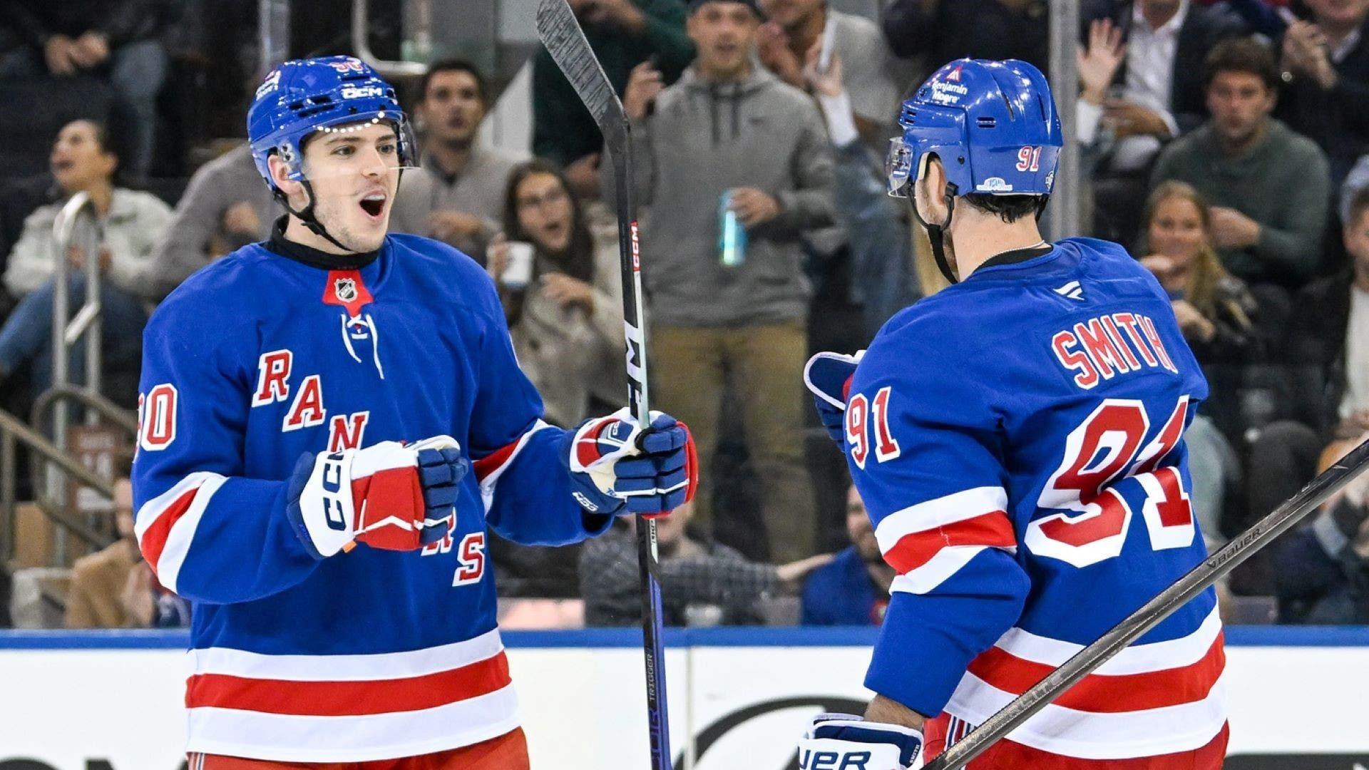 Oct 14, 2024; New York, New York, USA; New York Rangers defenseman Victor Mancini (90) celebrates the goal by New York Rangers right wing Reilly Smith (91) against the Detroit Red Wings during the third period at Madison Square Garden. / Dennis Schneidler-Imagn Images