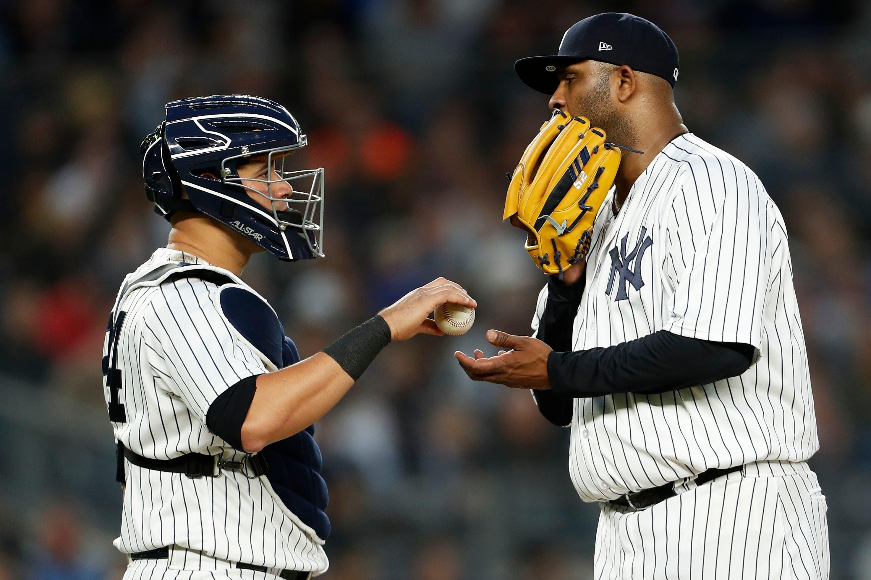 May 10, 2018; Bronx, NY, USA; New York Yankees catcher Gary Sanchez (24) gives a new ball to Yankees starting pitcher CC Sabathia (52) against the Boston Red Sox during the third inning at Yankee Stadium. Mandatory Credit: Adam Hunger-USA TODAY Sports / © Adam Hunger-USA TODAY Sports