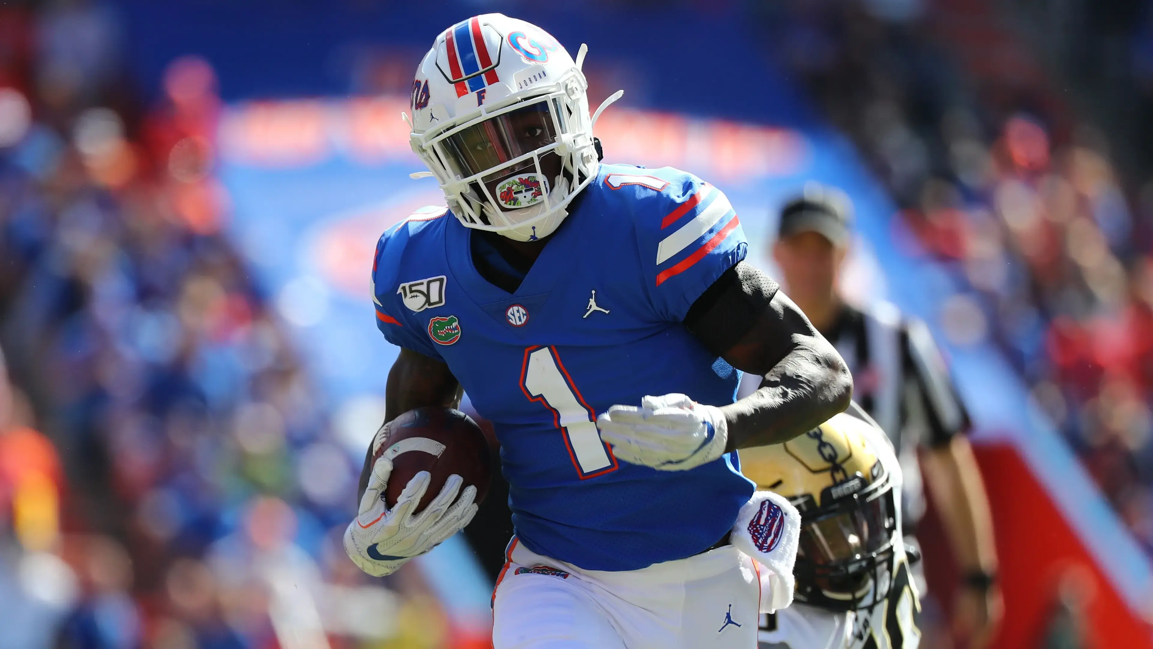 Nov 9, 2019; Gainesville, FL, USA; Florida Gators wide receiver Kadarius Toney (1) runs past Vanderbilt Commodores defensive lineman Dayo Odeyingbo (10) during the first quarter at Ben Hill Griffin Stadium. / © Kim Klement-USA TODAY Sports