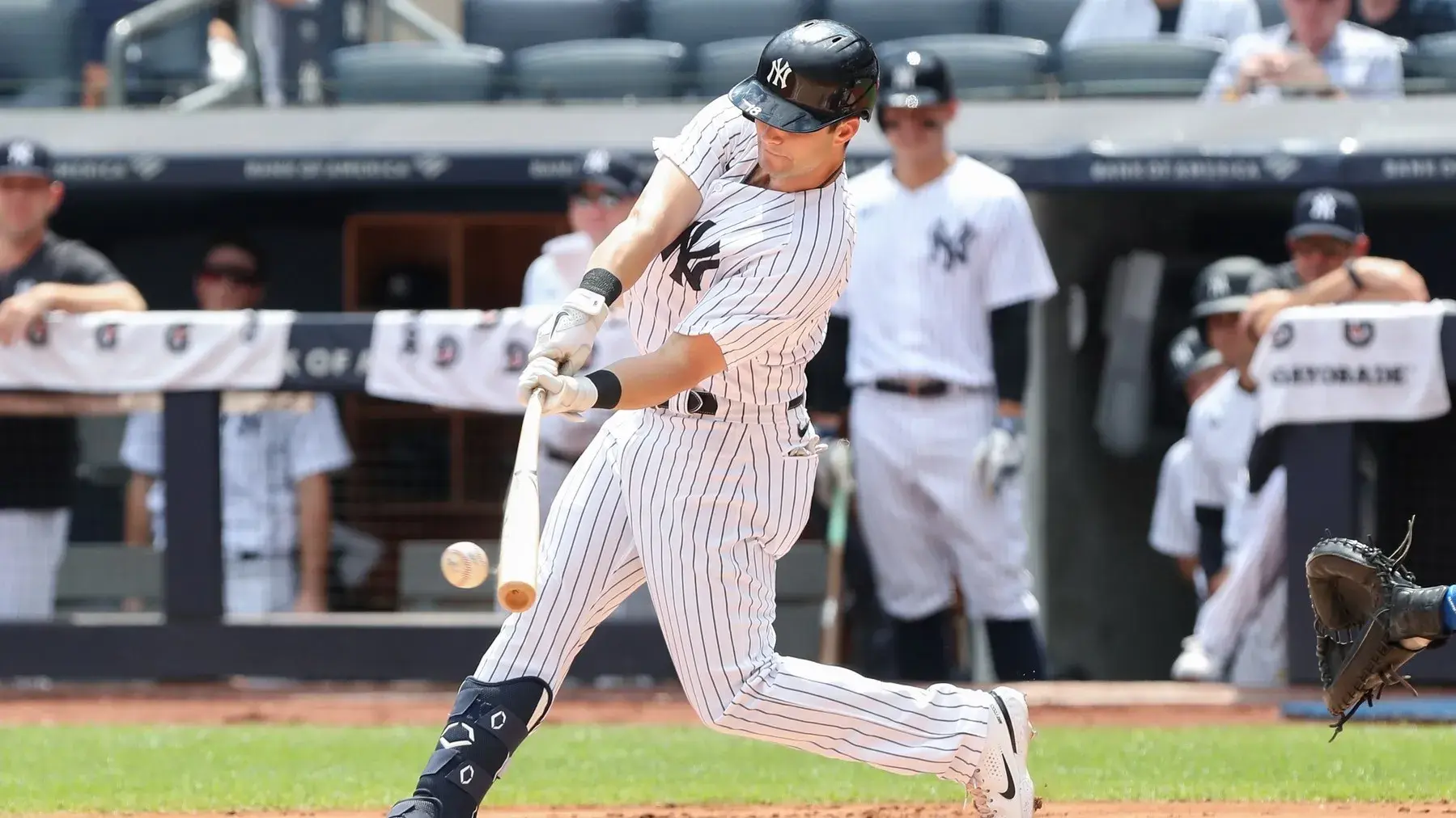 Aug 20, 2022; Bronx, New York, USA; New York Yankees left fielder Andrew Benintendi (18) hits a single against the Toronto Blue Jays during the first inning at Yankee Stadium. / Tom Horak-USA TODAY Sports