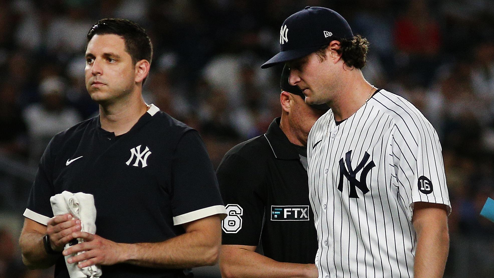 Sep 7, 2021; Bronx, New York, USA; New York Yankees starting pitcher Gerrit Cole (45) leaves the field with the trainer against the Toronto Blue Jays during the fourth inning at Yankee Stadium. Mandatory Credit: Andy Marlin-USA TODAY Sports