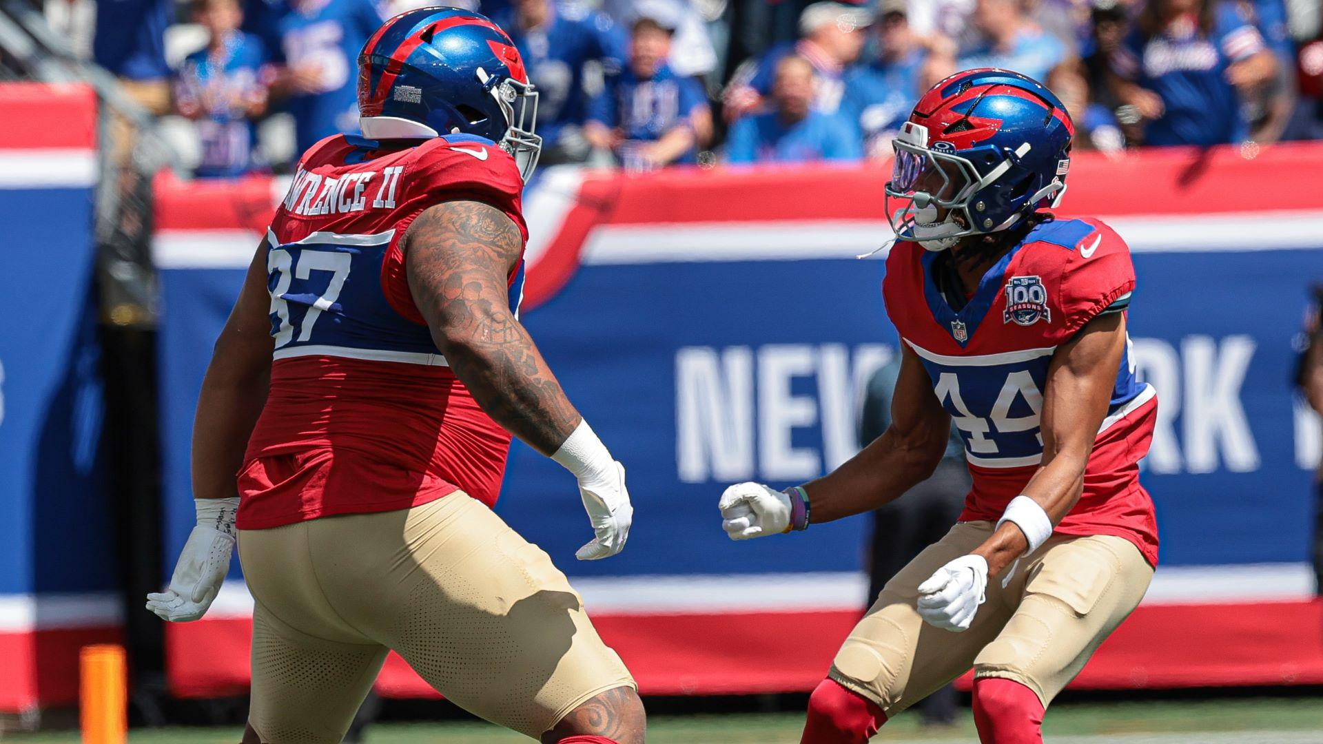 Sep 8, 2024; East Rutherford, New Jersey, USA; New York Giants defensive tackle Dexter Lawrence II (97) celebrates his sack with cornerback Nick McCloud (44) during the first quarter against the Minnesota Vikings at MetLife Stadium.