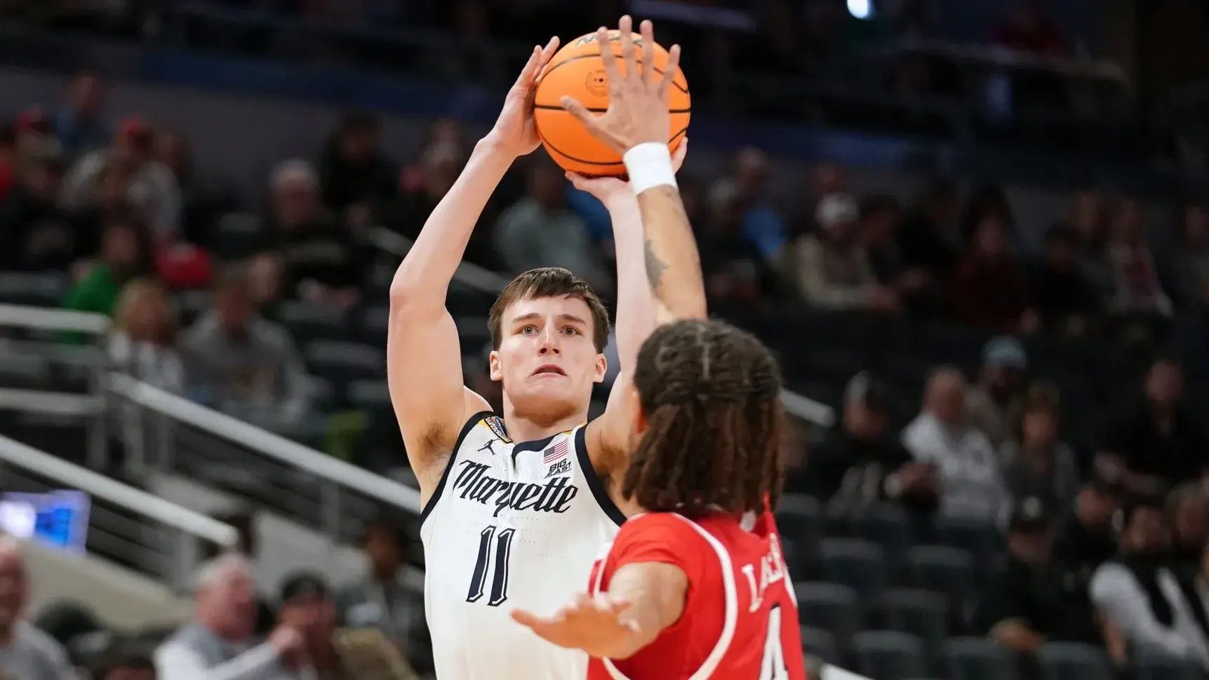 Mar 22, 2024; Indianapolis, IN, USA; Marquette Golden Eagles guard Tyler Kolek (11) shoots against Western Kentucky Hilltoppers guard Khristian Lander (4) in the first half in the first round of the 2024 NCAA Tournament at Gainbridge FieldHouse / Robert Goddin-USA TODAY Sports