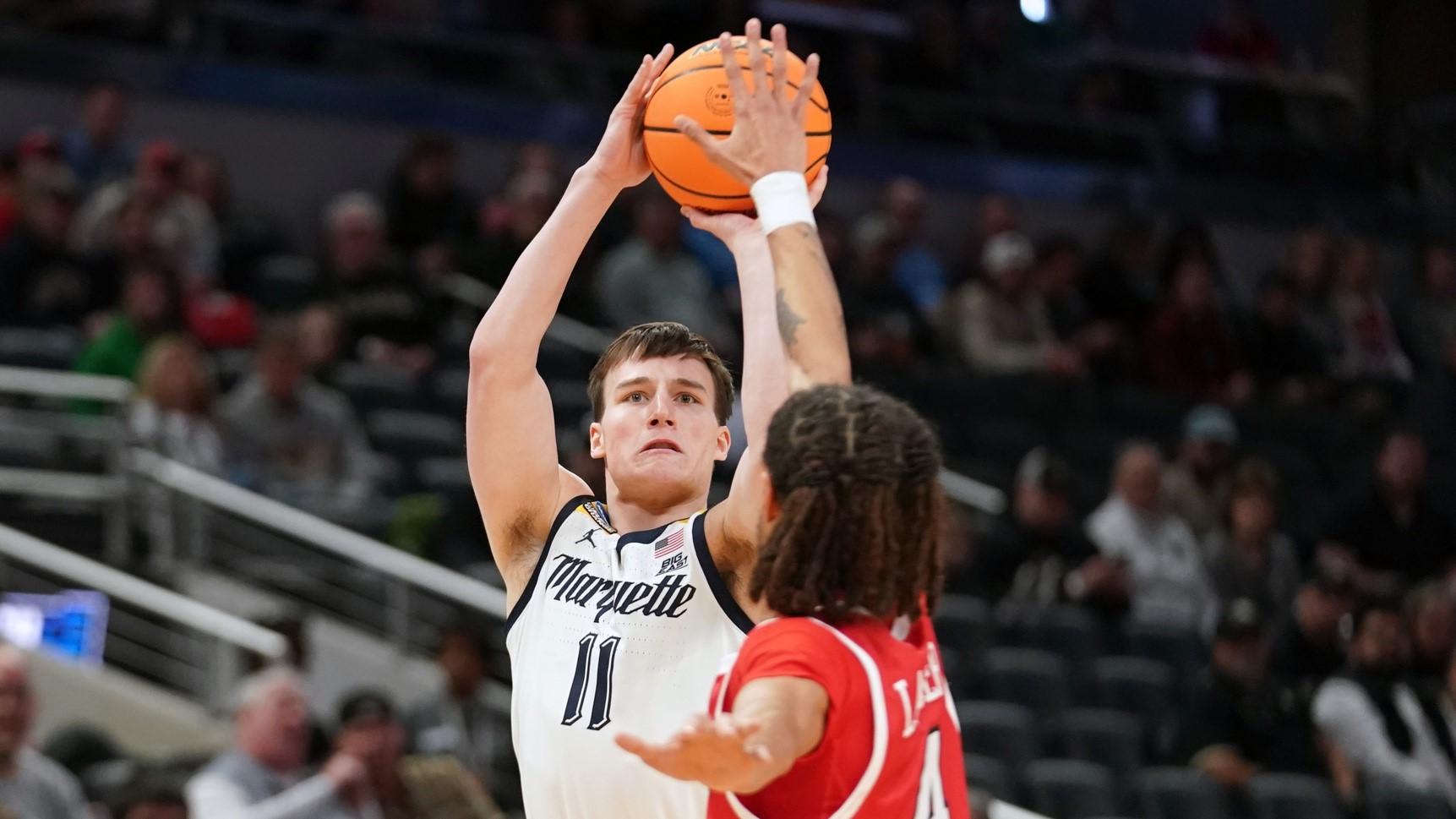 Mar 22, 2024; Indianapolis, IN, USA; Marquette Golden Eagles guard Tyler Kolek (11) shoots against Western Kentucky Hilltoppers guard Khristian Lander (4) in the first half in the first round of the 2024 NCAA Tournament at Gainbridge FieldHouse