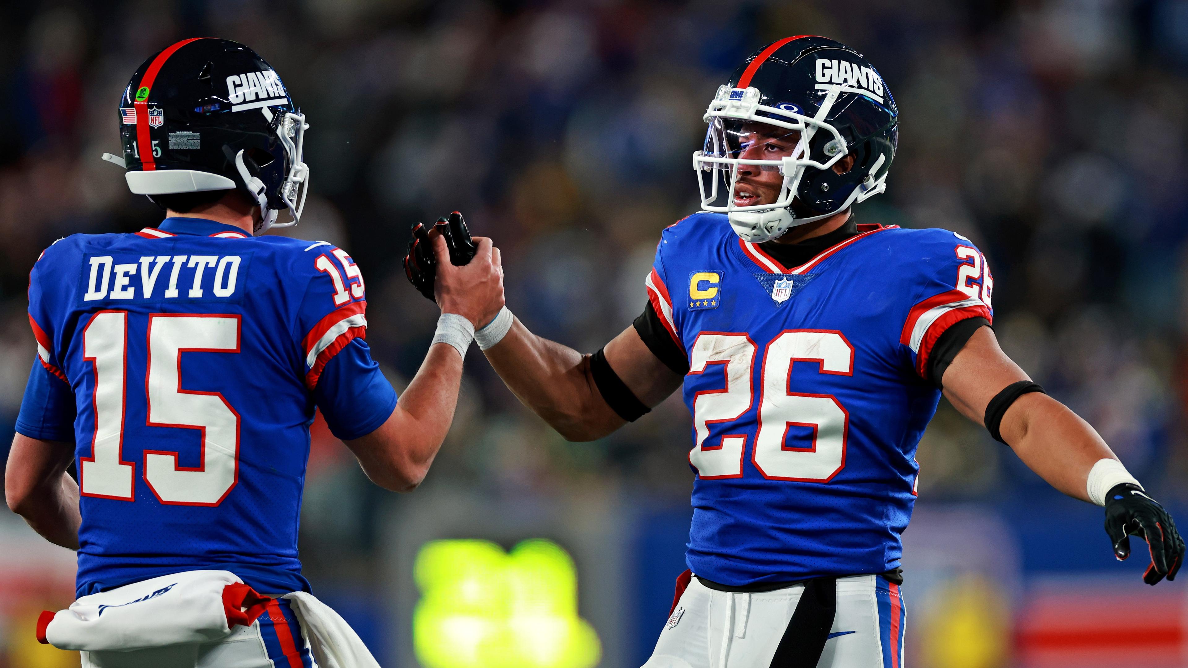 Dec 11, 2023; East Rutherford, New Jersey, USA; New York Giants running back Saquon Barkley (26) celebrates with quarterback Tommy DeVito (15) after scoring a touchdown during the third quarter against the Green Bay Packers at MetLife Stadium. Mandatory Credit: Vincent Carchietta-USA TODAY Sports