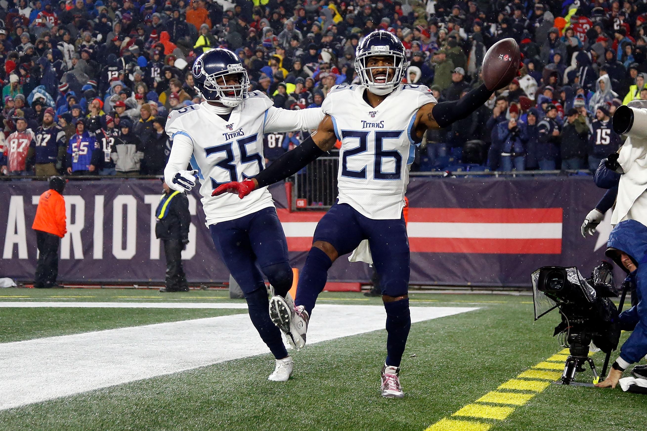 Jan 4, 2020; Foxborough, Massachusetts, USA; Tennessee Titans cornerback Logan Ryan (26) celebrates with defensive back Tramaine Brock (35) after scoring a touchdown on an interception against the New England Patriots during the second half at Gillette Stadium. Mandatory Credit: Winslow Townson-USA TODAY Sports