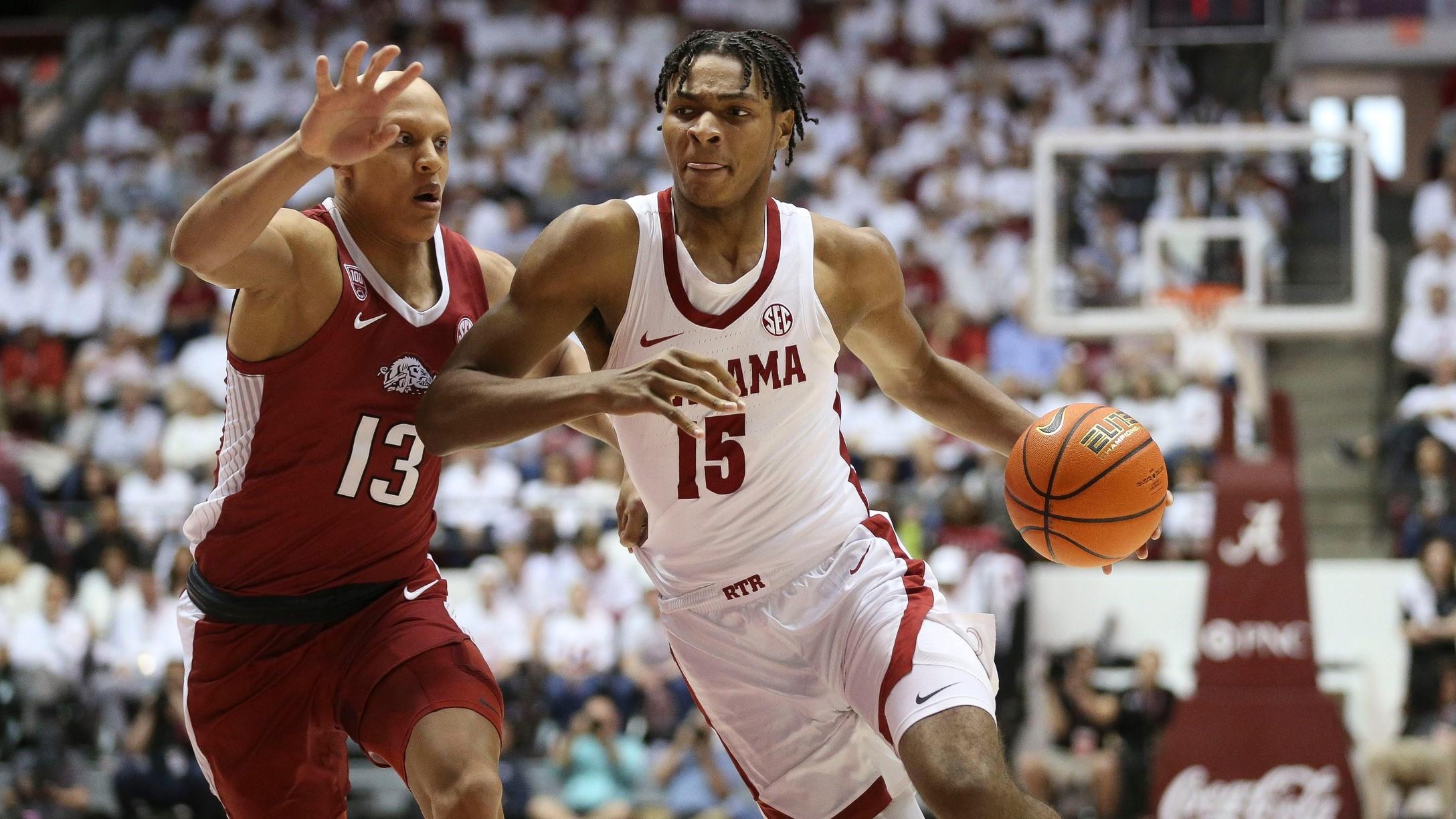 Feb 25, 2023; Tuscaloosa, AL, USA; Arkansas forward Jordan Walsh (13) guards Alabama forward Noah Clowney (15) as he drives into the lane at Coleman Coliseum.