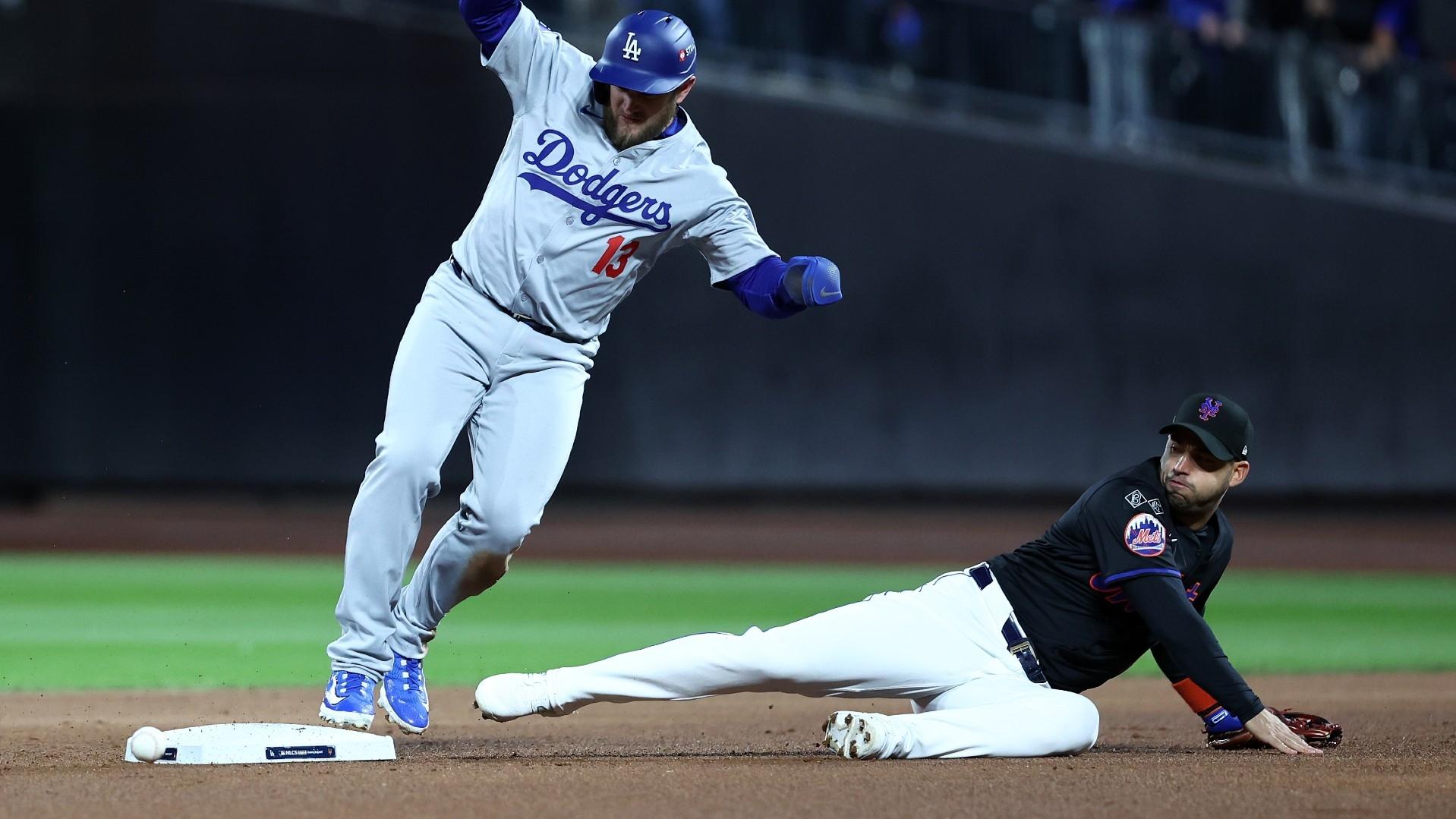 Los Angeles Dodgers third base Max Muncy (13) reaches second base against New York Mets second base Jose Iglesias (11) in the second inning during game three of the NLCS for the 2024 MLB playoffs at Citi Field. Mandatory Credit: 