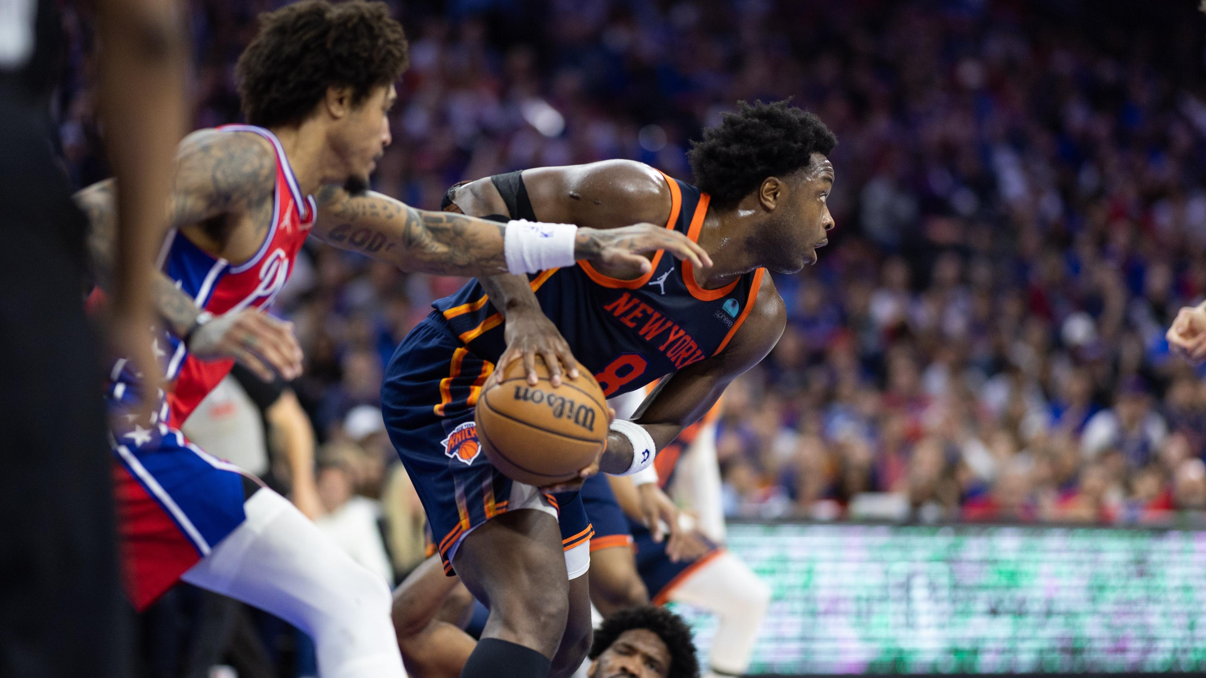 Apr 28, 2024; Philadelphia, Pennsylvania, USA; New York Knicks guard OG Anunoby (8) picks up a loose ball in front of Philadelphia 76ers center Joel Embiid (21) during the first half of game four of the first round in the 2024 NBA playoffs at Wells Fargo Center. Mandatory Credit: Bill Streicher-USA TODAY Sports