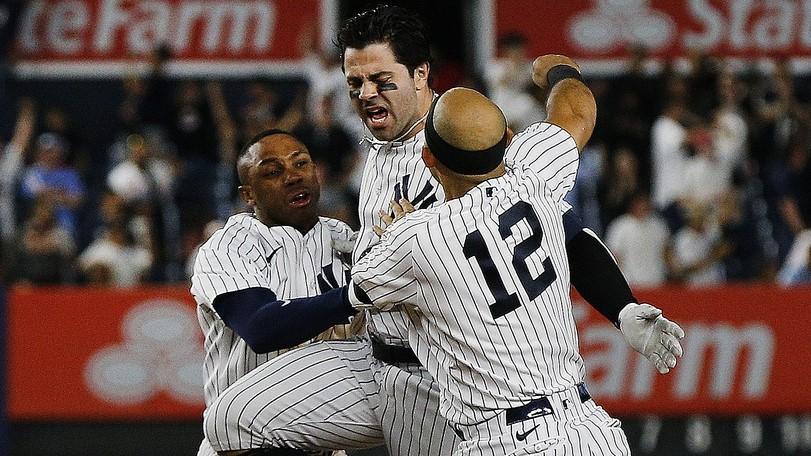 Jul 21, 2021; Bronx, New York, USA; New York Yankees pinch hitter Ryan LaMarre (center) is congratulated by his teammates after hitting the game winning single against the Philadelphia Phillies during the tenth inning at Yankee Stadium.