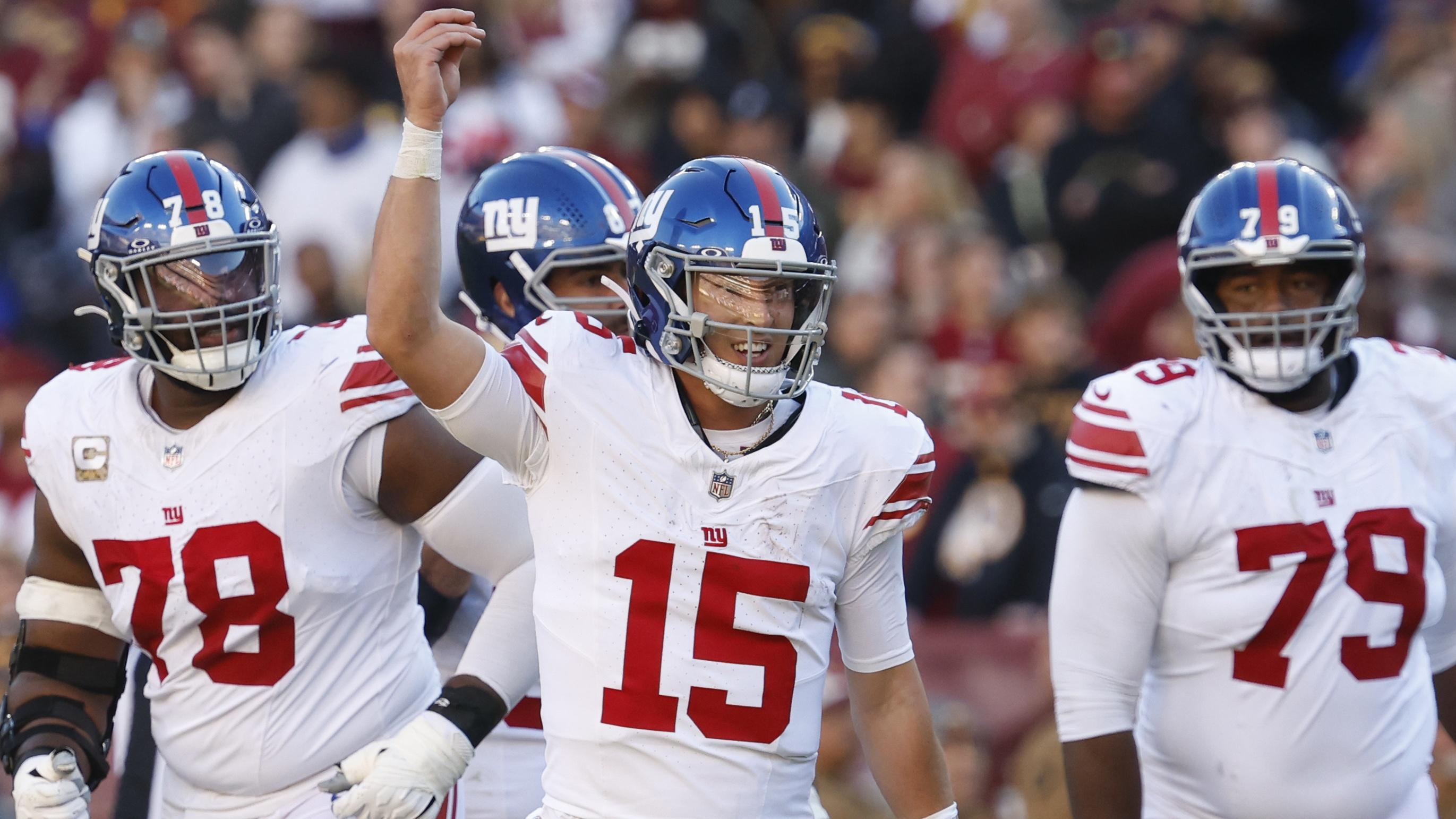 New York Giants quarterback Tommy DeVito (15) celebrates after throwing a touchdown pass against the Washington Commanders during the second quarter at FedExField