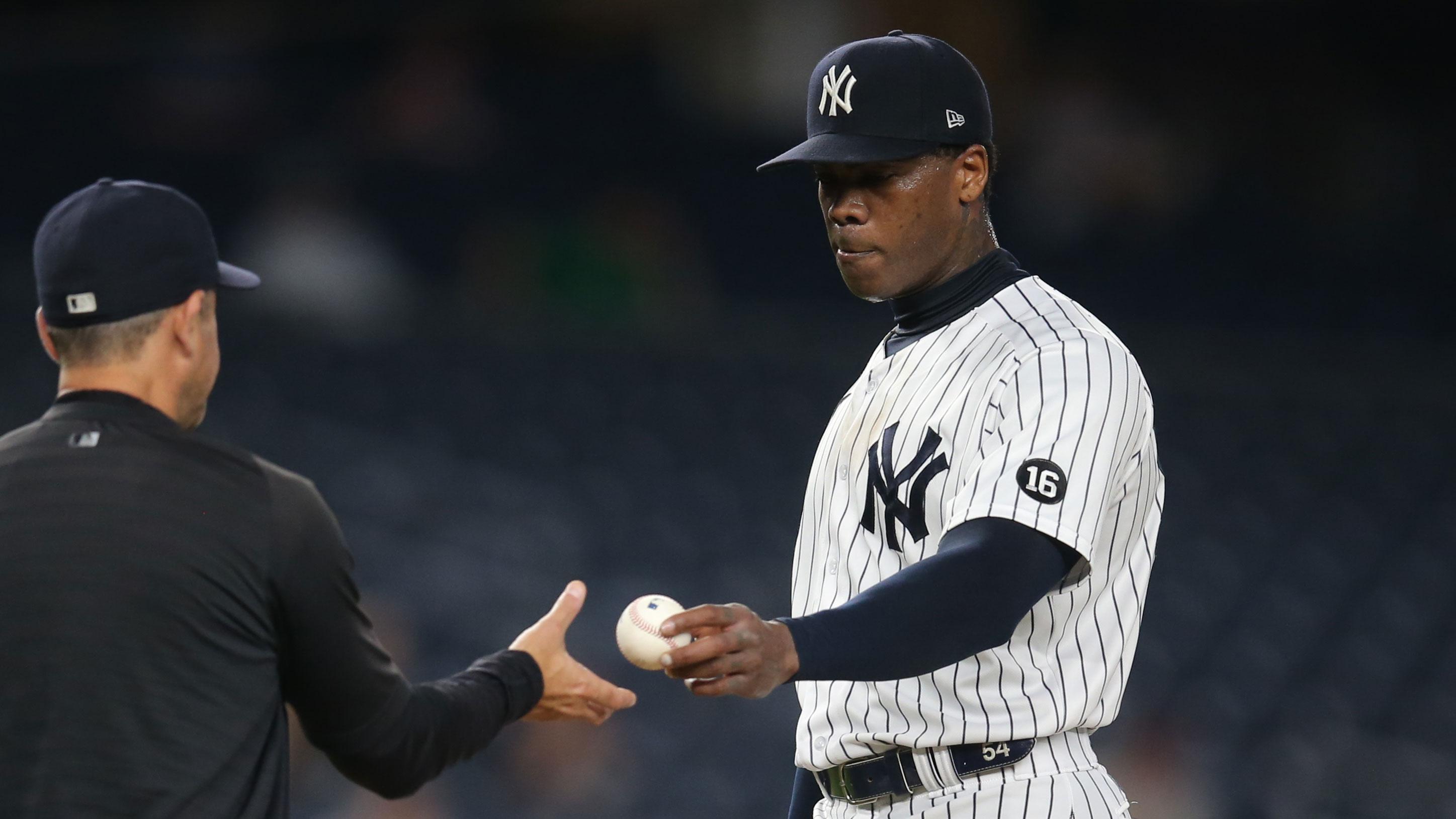 Jun 30, 2021; Bronx, New York, USA; New York Yankees manager Aaron Boone (left) takes relief pitcher Aroldis Chapman (right) out of the game against the Los Angeles Angels during the ninth inning at Yankee Stadium.