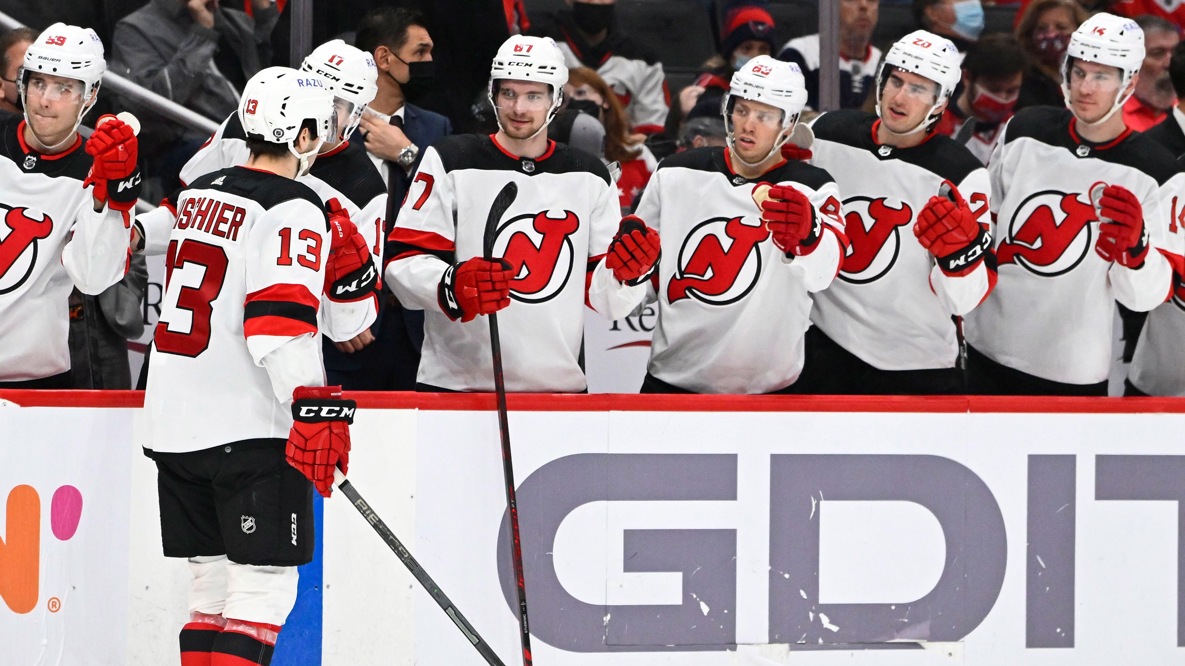 New Jersey Devils center Nico Hischier (13) is congratulated by teammates after scoring a goal against the Washington Capitals during the second period at Capital One Arena.