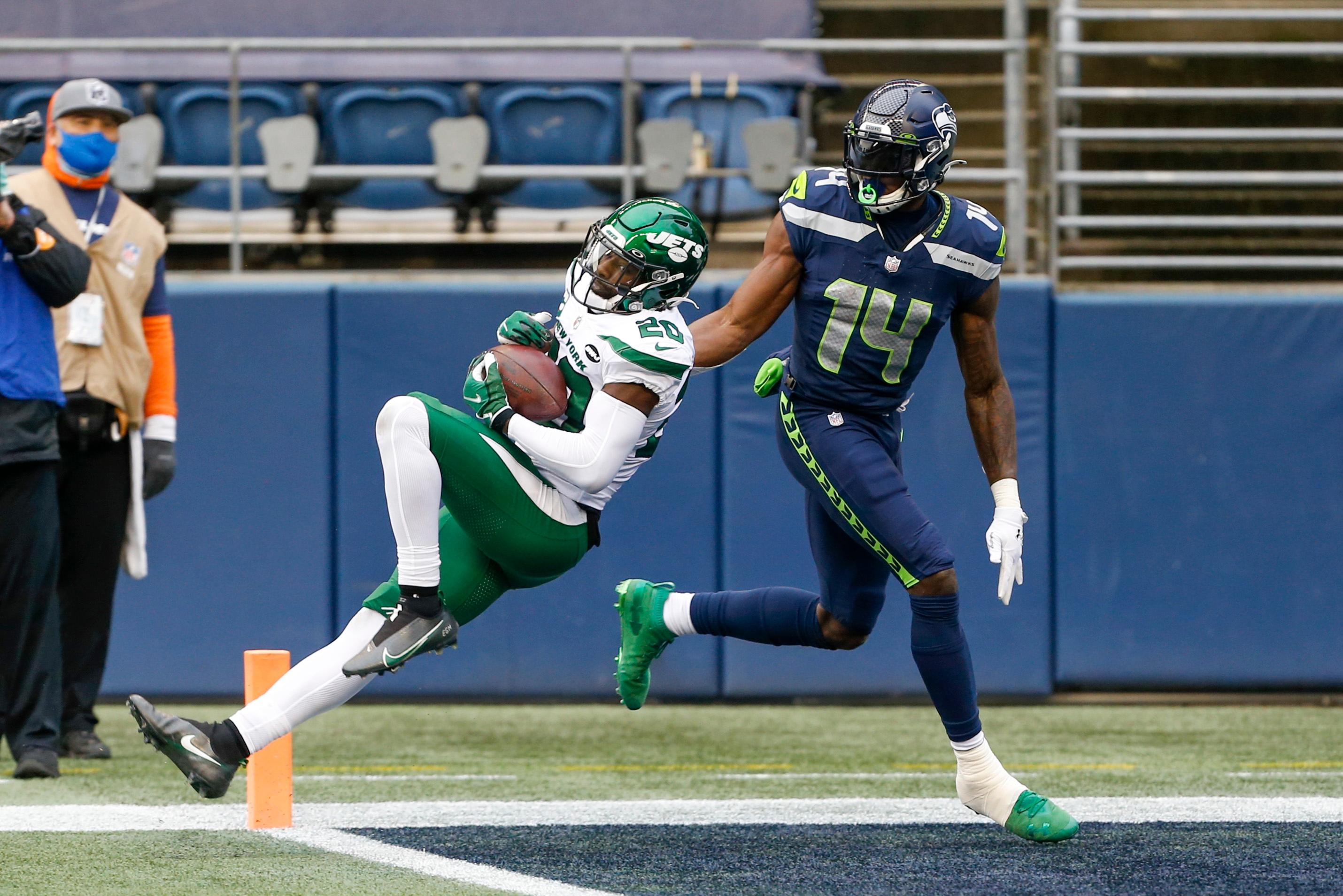 Dec 13, 2020; Seattle, Washington, USA; New York Jets free safety Marcus Maye (20) intercepts a pass intended for Seattle Seahawks wide receiver DK Metcalf (14) during the first quarter at Lumen Field. Mandatory Credit: Joe Nicholson-USA TODAY Sports