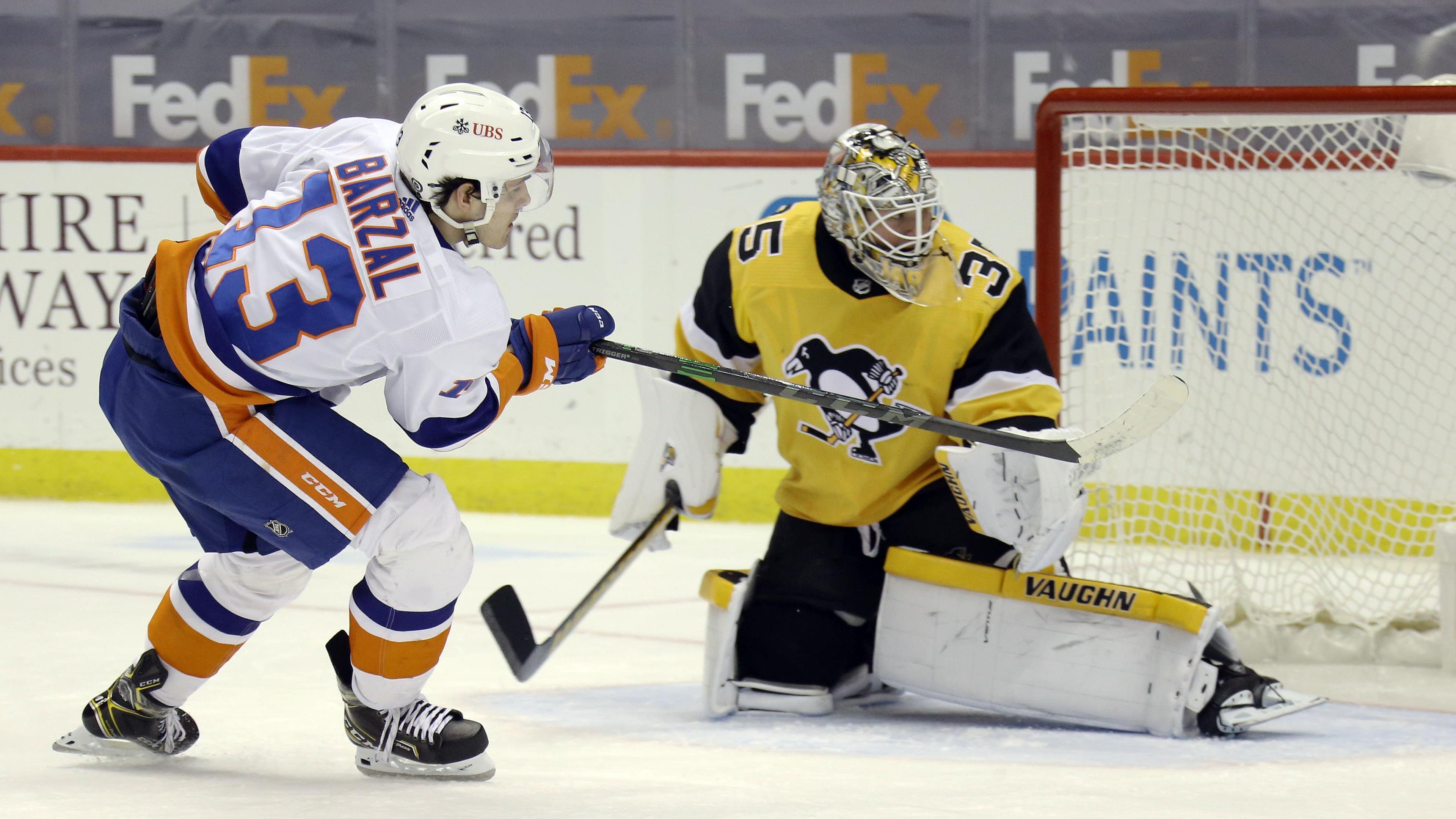 Mar 27, 2021; Pittsburgh, Pennsylvania, USA; New York Islanders center Mathew Barzal (13) scores a goal against Pittsburgh Penguins goaltender Tristan Jarry (35) during the second period at PPG Paints Arena. Mandatory Credit: Charles LeClaire-USA TODAY Sports / Charles LeClaire-USA TODAY Sports