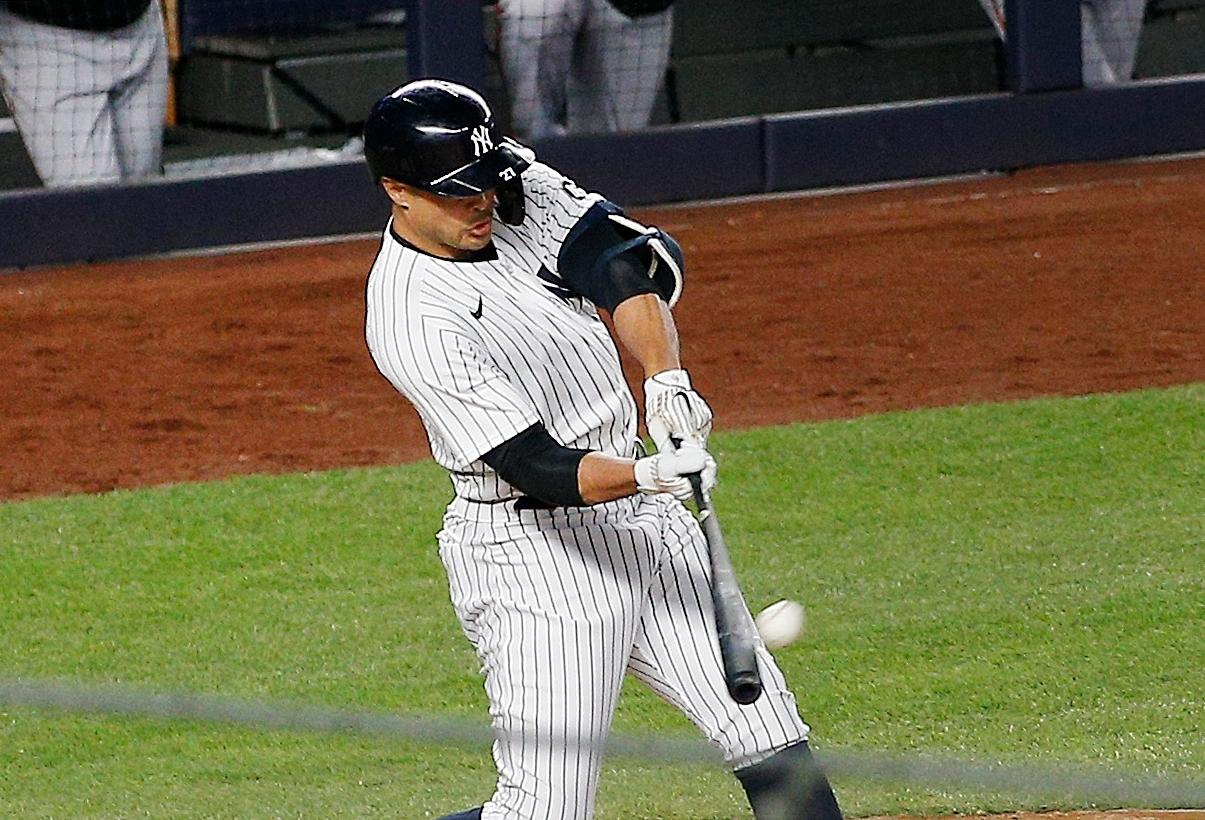 Apr 5, 2021; Bronx, New York, USA; New York Yankees designated hitter Giancarlo Stanton (27) hits a grand slam home run against the Baltimore Orioles during the fifth inning at Yankee Stadium. Mandatory Credit: Andy Marlin-USA TODAY Sports