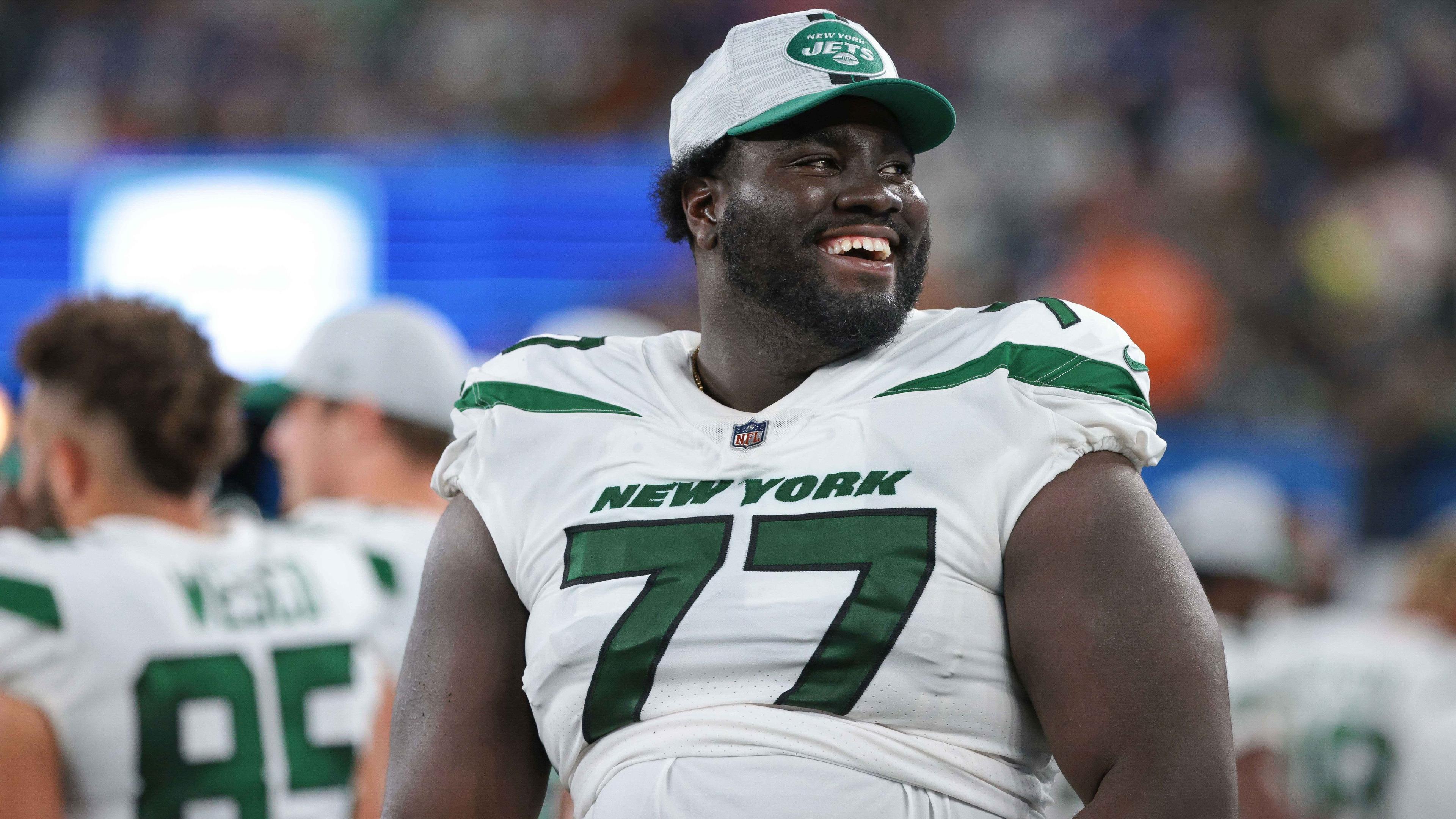 Aug 14, 2021; East Rutherford, New Jersey, USA; New York Jets offensive tackle Mekhi Becton (77) laughs during the second half against the New York Giants at MetLife Stadium.