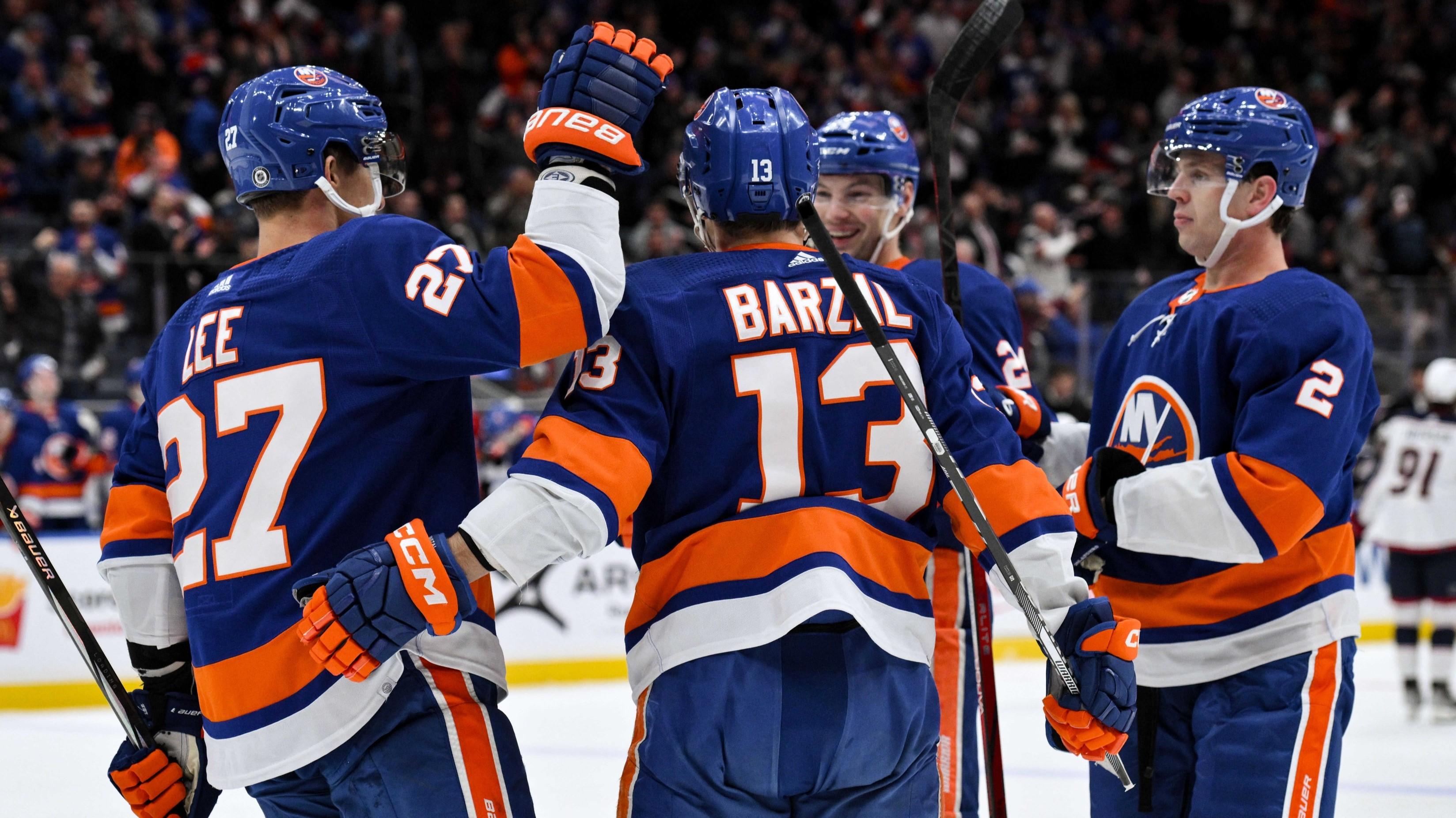 Dec 7, 2023; Elmont, New York, USA; New York Islanders center Mathew Barzal (13) celebrates with teammates after scoring a goal against the Columbus Blue Jackets during the second period at UBS Arena.