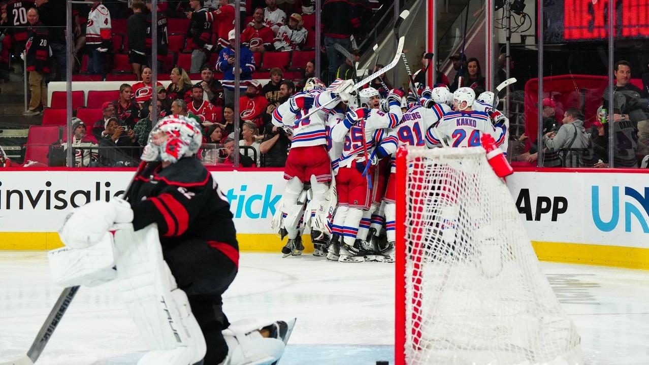 New York Rangers players celebrate their win in the overtime against the Carolina Hurricanes in game three of the second round of the 2024 Stanley Cup Playoffs at PNC Arena.