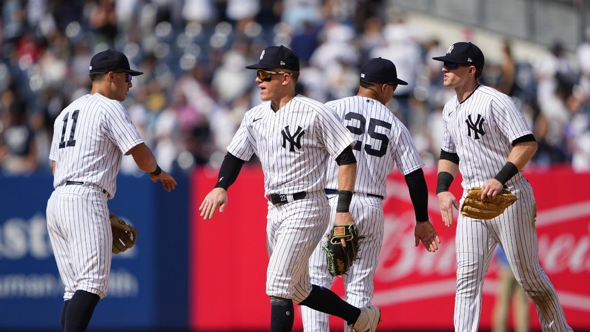 New York Yankees shortstop Anthony Volpe (11) and center fielder Harrison Bader (22) and second baseman Gleybor Torres (25) and left fielder Billy McKinney (57) celebrate the victory after the game against the Texas Rangers at Yankee Stadium.