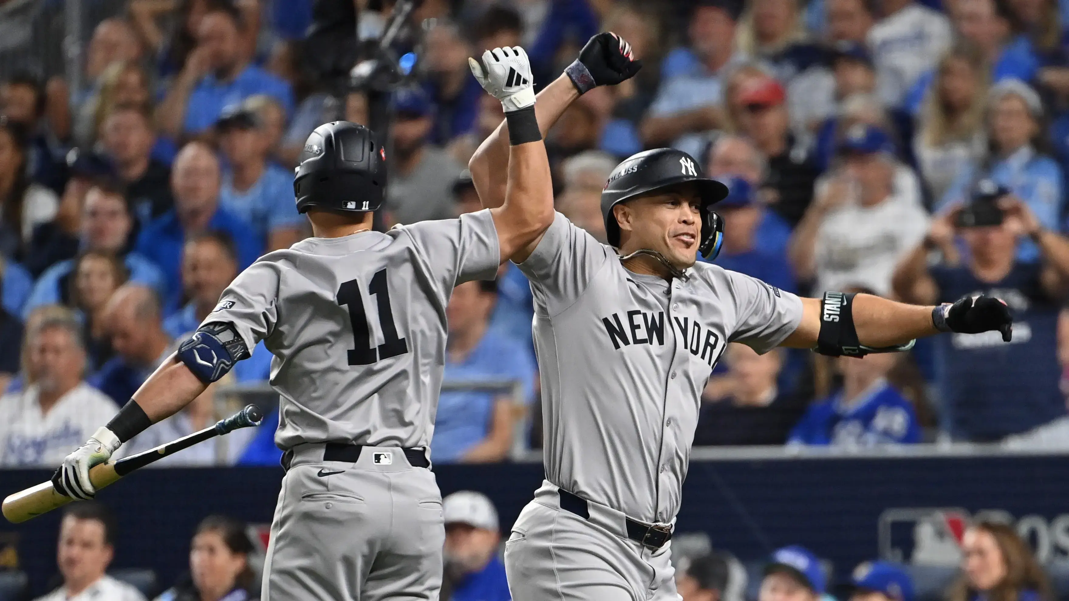 Oct 9, 2024; Kansas City, Missouri, USA; New York Yankees designated hitter Giancarlo Stanton (27) celebrates with New York Yankees third base Jazz Chisholm Jr. (13) after the hitting a home run in the eighth inning against the Kansas City Royals during game three of the NLDS for the 2024 MLB Playoffs at Kauffman Stadium. Mandatory Credit: Peter Aiken-Imagn Images / © Peter Aiken-Imagn Images