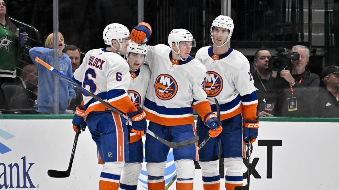 New York Islanders defenseman Ryan Pulock (6) and defenseman Sebastian Aho (25) and center Kyle MacLean (32) and left wing Pierre Engvall (18) celebrates a goal scored by MacLean against the Dallas Stars during the second period at the American Airlines Center.