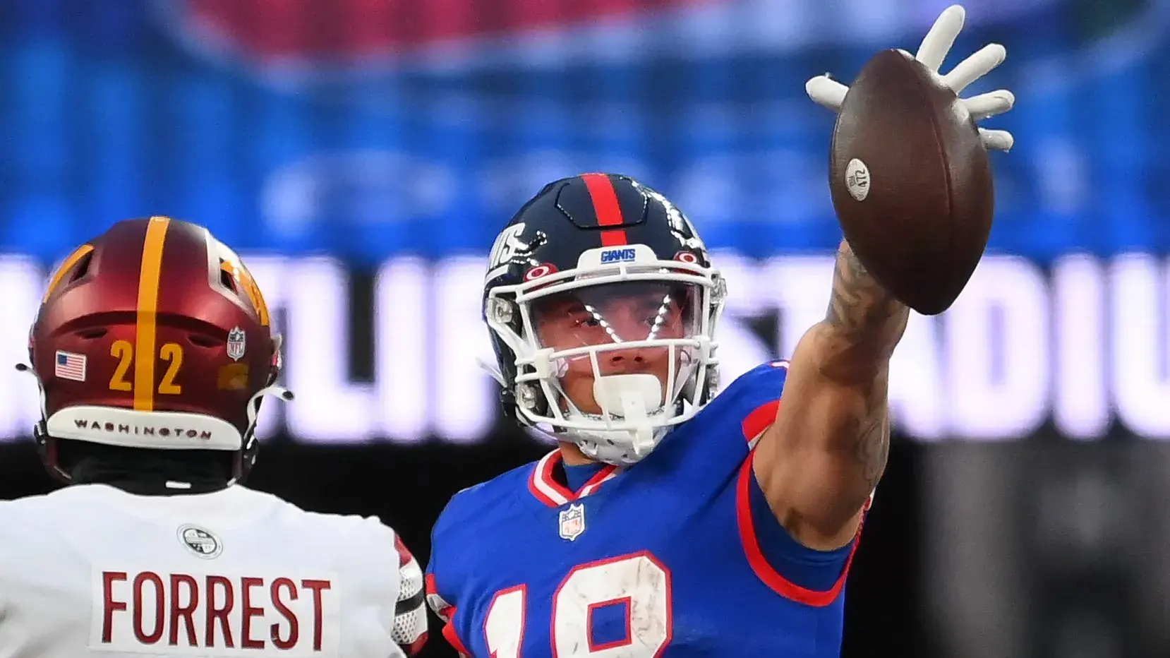 Dec 4, 2022; East Rutherford, New Jersey, USA; New York Giants wide receiver Isaiah Hodgins (18) reacts to a first down catch as Washington Commanders cornerback Danny Johnson (36) and safety Darrick Forrest (22) look on during overtime at MetLife Stadium. Mandatory Credit: Rich Barnes-USA TODAY Sports / © Rich Barnes-USA TODAY Sports