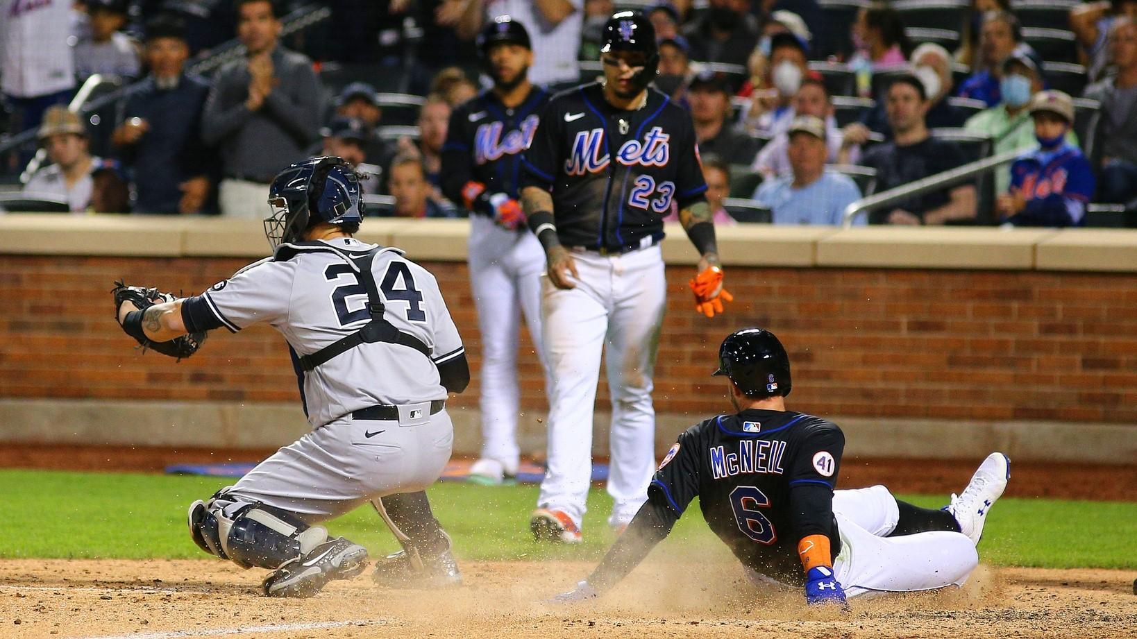 New York Mets left fielder Jeff McNeil (6) scores on a throwing error by New York Yankees shortstop Gleyber Torres (not pictured) during the seventh inning at Citi Field.