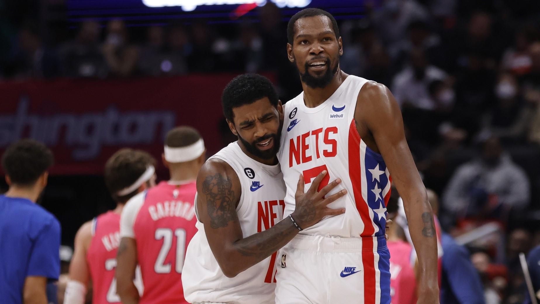 Dec 12, 2022; Washington, District of Columbia, USA; Brooklyn Nets guard Kyrie Irving (11) celebrates with Nets forward Kevin Durant (7) against the Washington Wizards in the fourth quarter at Capital One Arena.