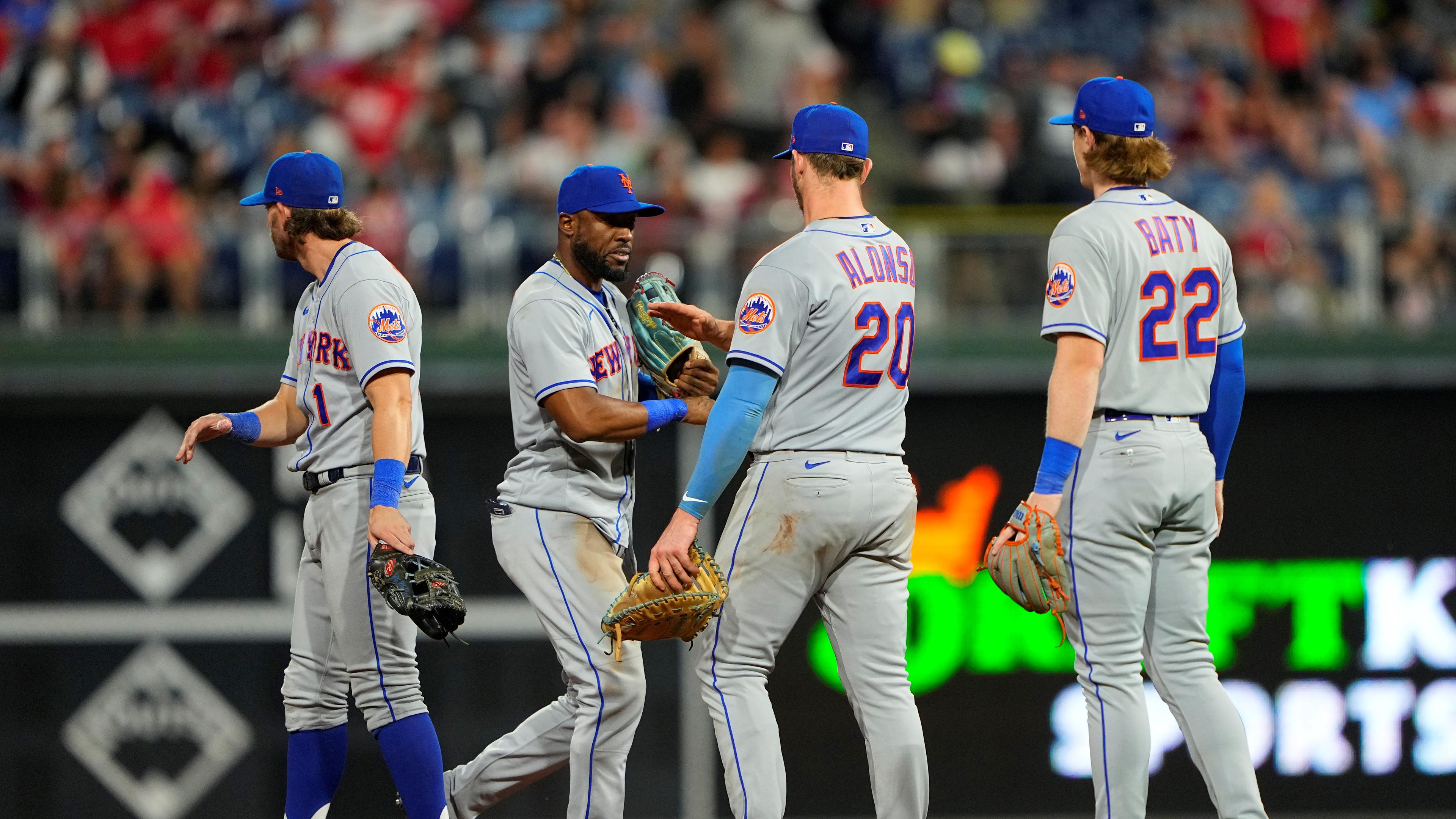 New York Mets first baseman Pete Alonzo (20) and right fielder Starling Marte (6) slap hands along with second baseman Jeff McNeil (1) and third baseman Brett Baty (22)