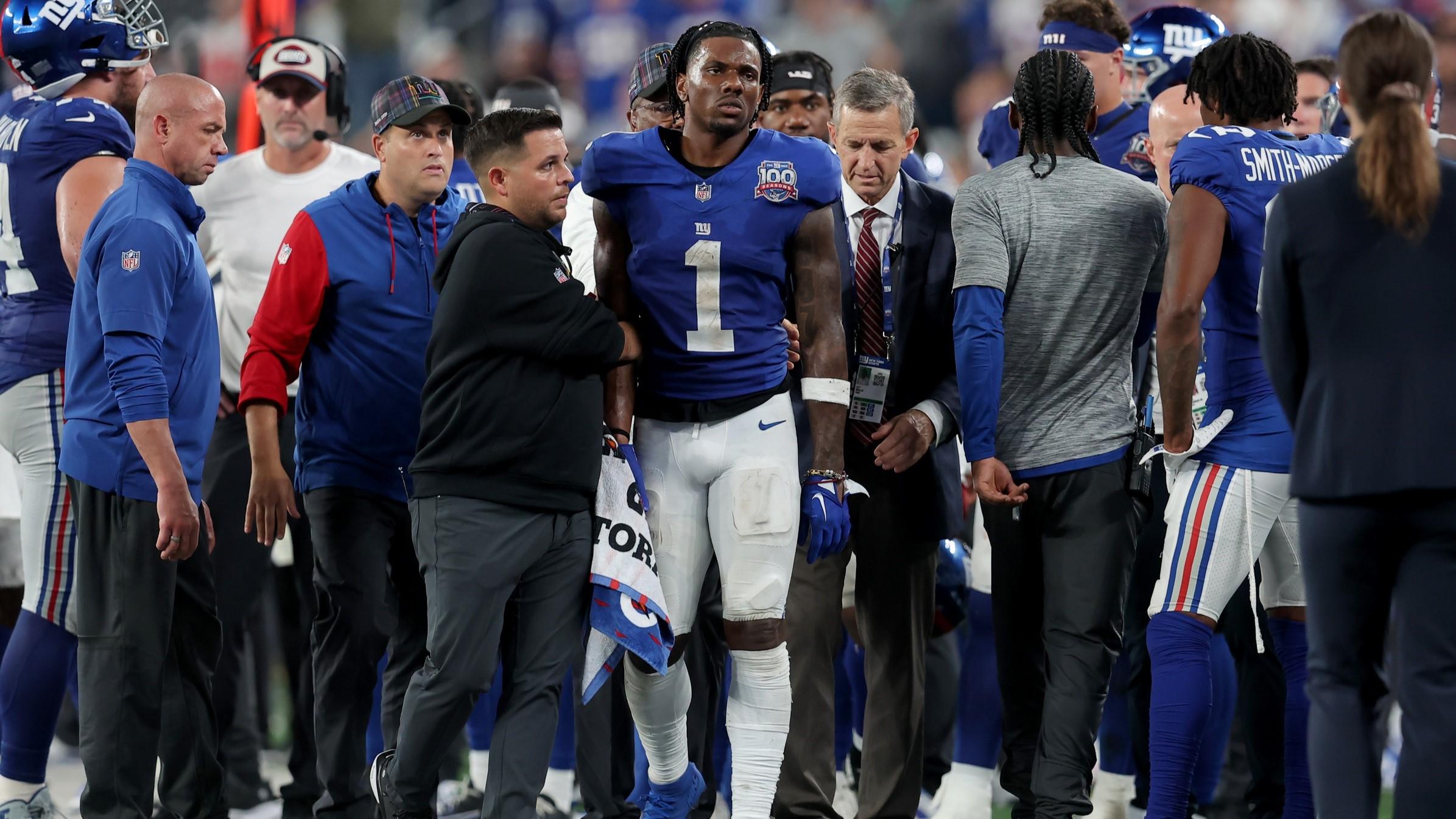 Sep 26, 2024; East Rutherford, New Jersey, USA; New York Giants wide receiver Malik Nabers (1) is helped off the field after an injury during the fourth quarter against the Dallas Cowboys at MetLife Stadium