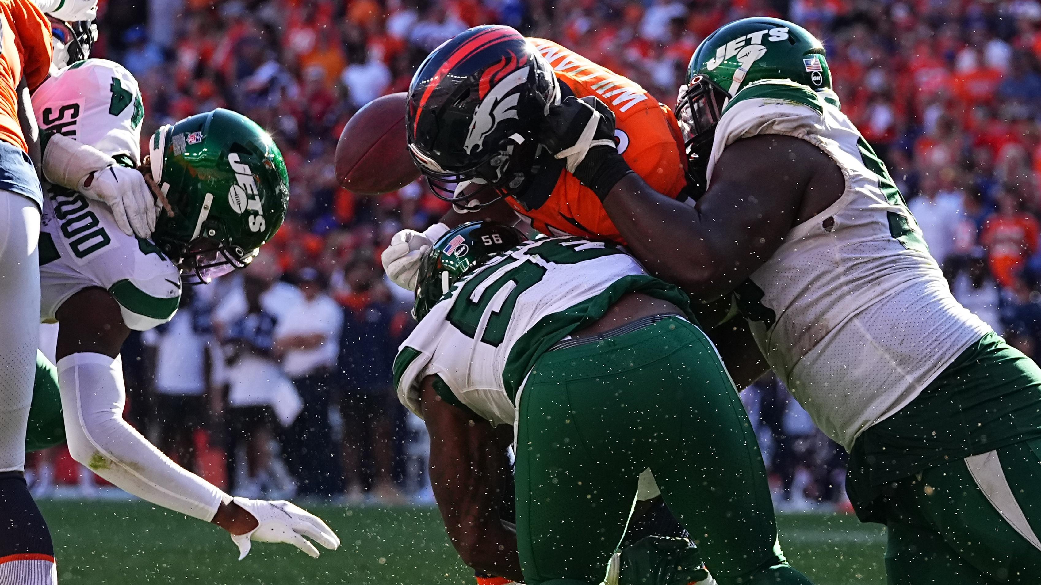 Sep 26, 2021; Denver, Colorado, USA; Denver Broncos running back Javonte Williams (33) fumbles the ball after a tackle by New York Jets outside linebacker Quincy Williams (56) and defensive tackle Foley Fatukasi (94) in the fourth quarter at Empower Field at Mile High.