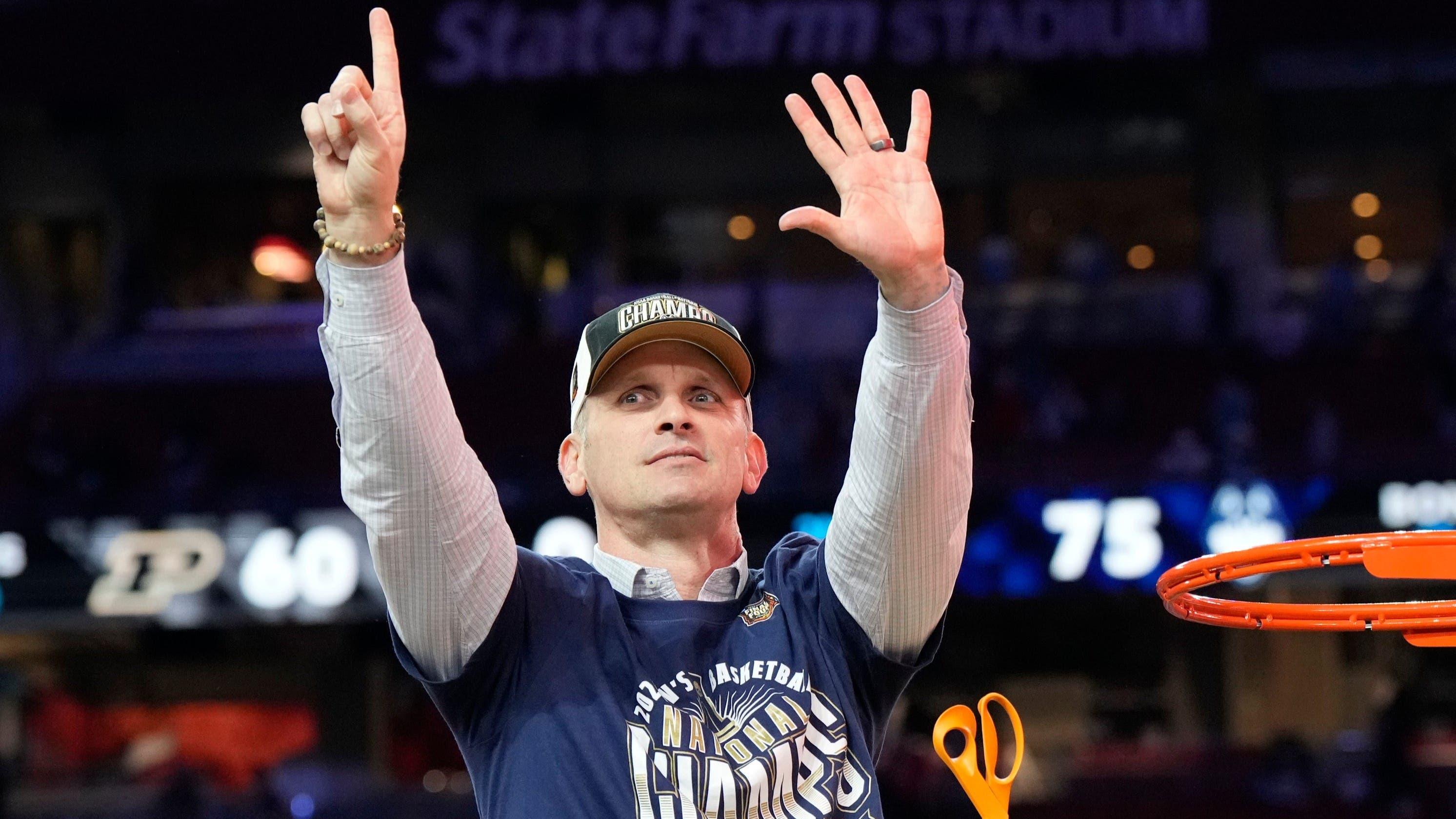 Connecticut Huskies head coach Dan Hurley cuts the basketball net winning the Men's NCAA national championship game against the Purdue Boilermakers at State Farm Stadium in Glendale on April 8, 2024.