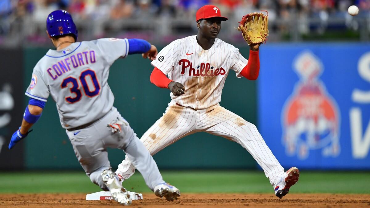 Philadelphia Phillies shortstop Didi Gregorius (18) attempts to turn a double play over New York Mets right fielder Michael Conforto (30) in the sixth inning at Citizens Bank Park.