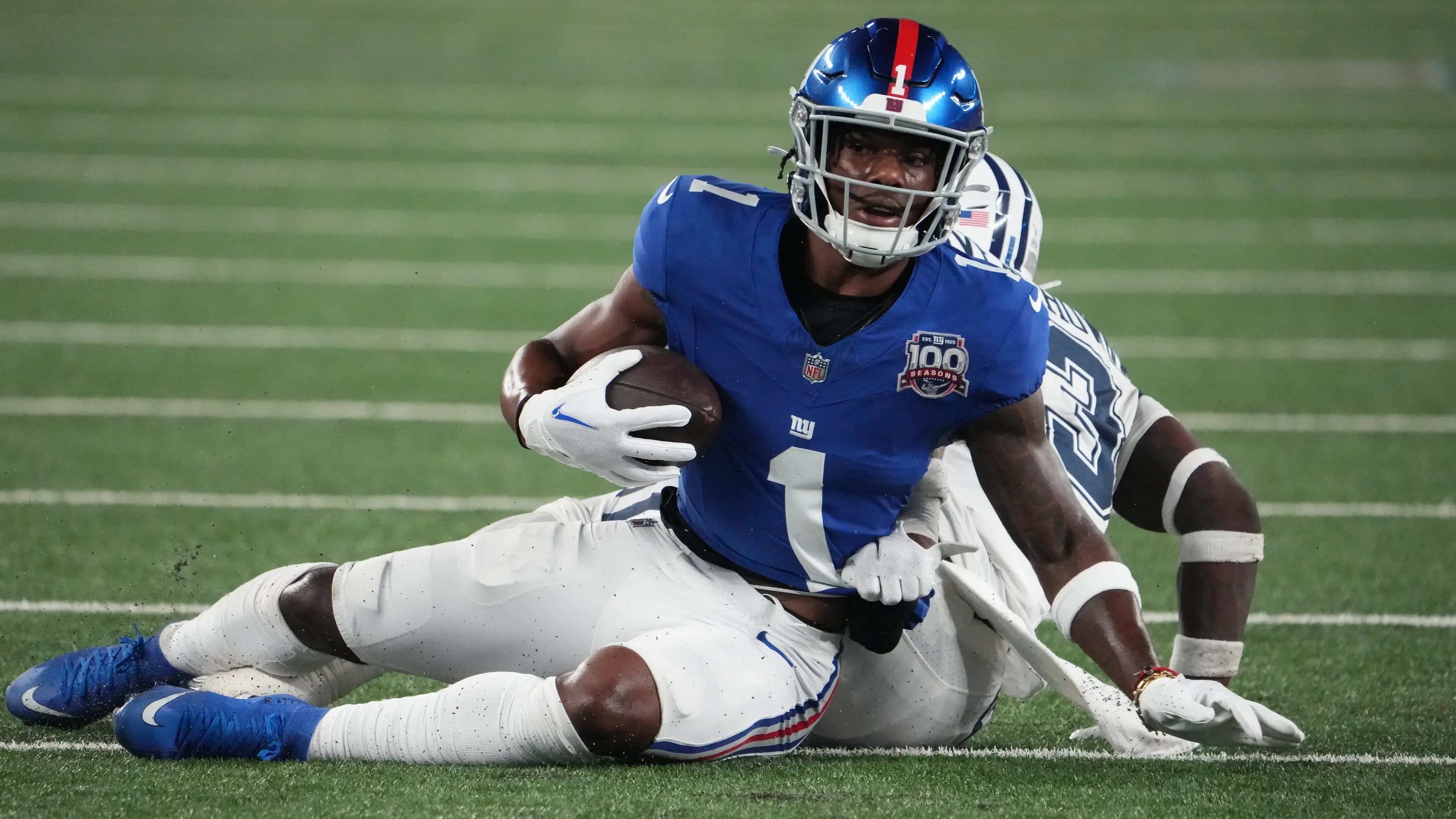 Sep 26, 2024; East Rutherford, New Jersey, USA; New York Giants wide receiver Malik Nabers (1) on a short gain against Dallas Cowboys linebacker DeMarvion Overshown (13) during the first half at MetLife Stadium. Mandatory Credit: Robert Deutsch-Imagn Images / © Robert Deutsch-Imagn Images