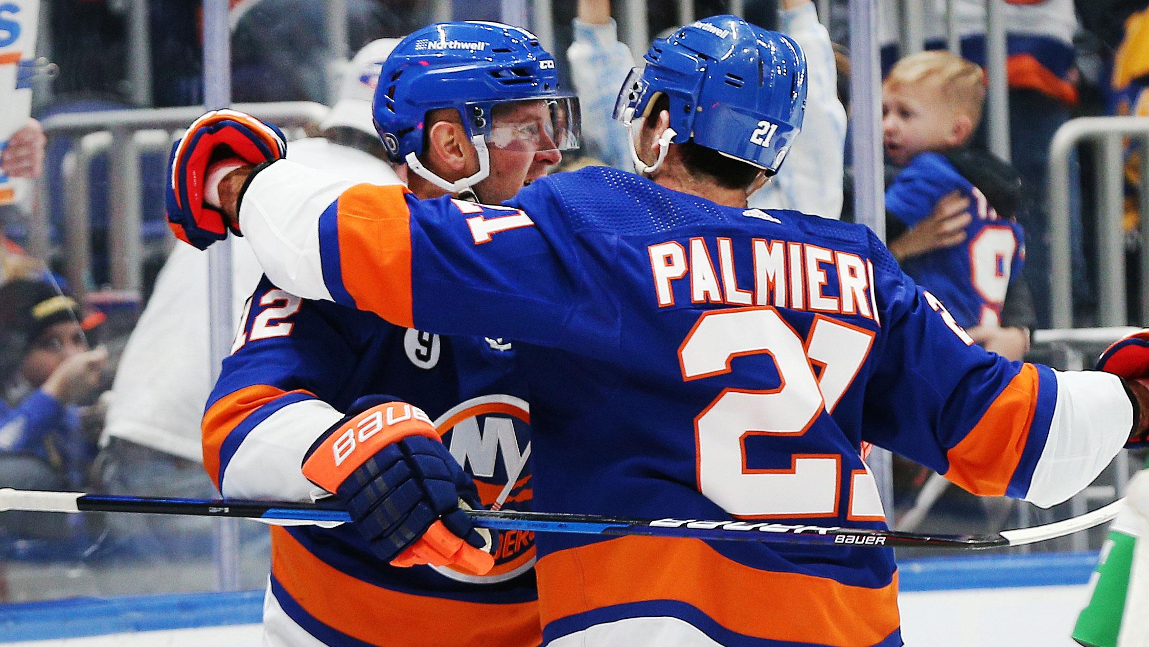 Mar 11, 2022; Elmont, New York, USA; New York Islanders right wing Josh Bailey (12) is congratulated by right wing Kyle Palmieri (21) after scoring a goal against the Winnipeg Jets during the second period at UBS Arena.