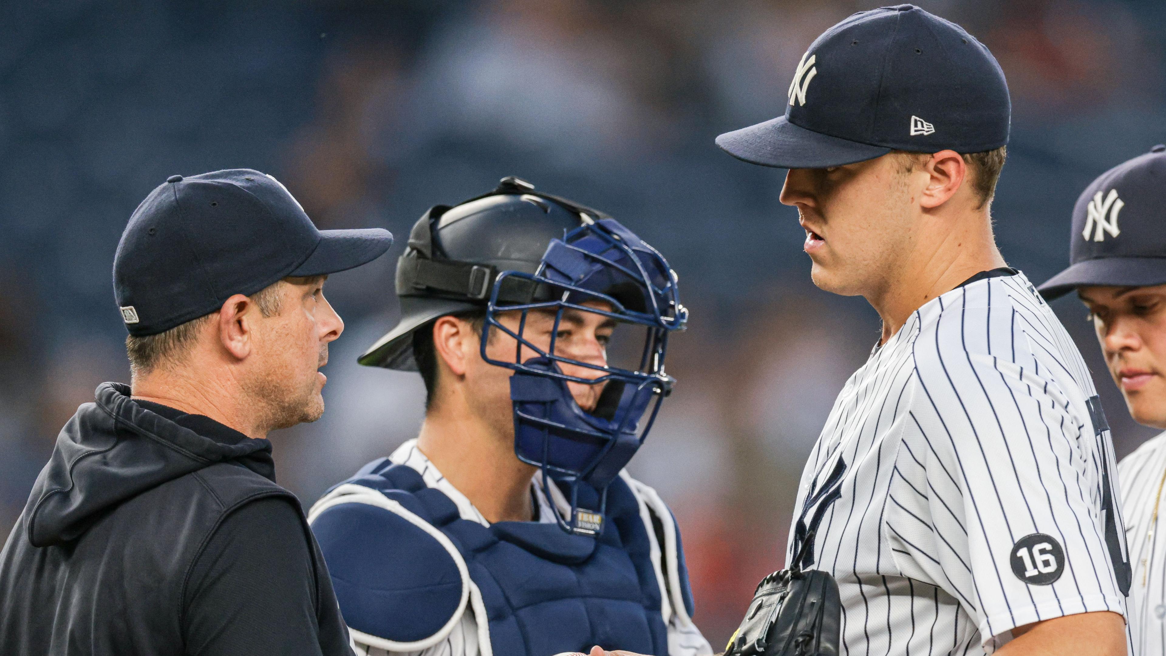 Jun 18, 2021; Bronx, New York, USA; New York Yankees starting pitcher Jameson Taillon (50) hands the ball to manager Aaron Boone (17) in front of catcher Kyle Higashioka (66) during the fifth inning against the Oakland Athletics at Yankee Stadium. Mandatory Credit: Vincent Carchietta-USA TODAY Sports