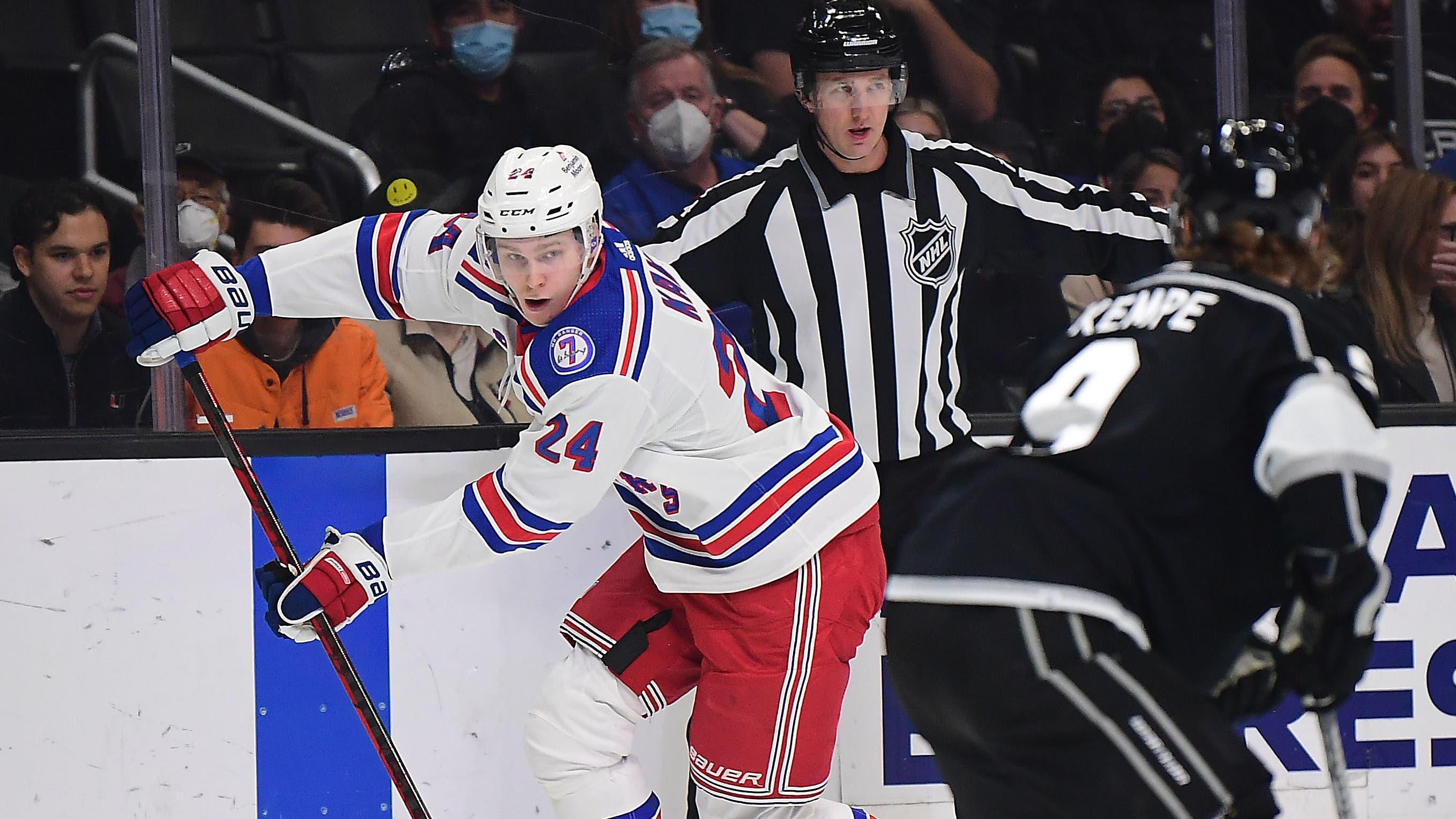 Jan 10, 2022; Los Angeles, California, USA; New York Rangers right wing Kaapo Kakko (24) moves the puck against Los Angeles Kings center Adrian Kempe (9) during the first period at Crypto.com Arena. Mandatory Credit: Gary A. Vasquez-USA TODAY Sports / Gary A. Vasquez-USA TODAY Sports