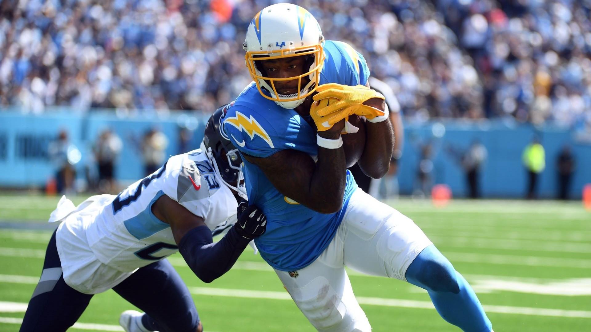 Sep 17, 2023; Nashville, Tennessee, USA; Los Angeles Chargers wide receiver Mike Williams (81) runs after a catch against Tennessee Titans cornerback Tre Avery (23) during the first half at Nissan Stadium.